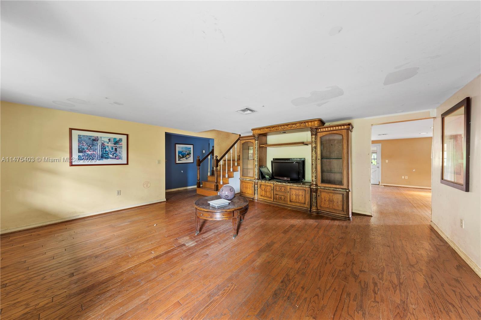OPENS TO FAMILY ROOM WHICH SHARES SPACE WITH CUSTOM KITCHEN