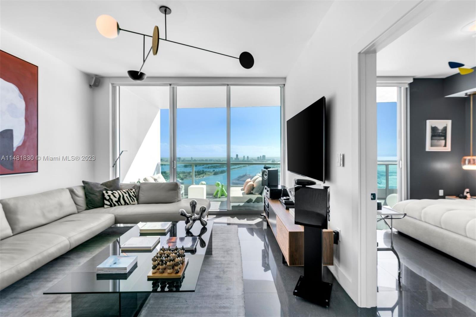 An impeccably designed 1 Bed + Den/ 2 Bath condo at 900 Biscayne Bay with 912 interior square feet, 9-foot-8-inch-high floor-to-ceiling glass windows, motorized shades, and a spacious terrace overlooking Biscayne Bay and the Atlantic Ocean from the 46th floor. Building amenities include a resort-style pool, lap pool, hot tub, fully-equipped fitness center, men's and women's sauna and steam room, movie theater, BBQ area, clubroom, full-service concierge, valet parking service, and a children's playroom. Within walking distance of the Miami Heat Arena, Bayside Marketplace, Maurice A. Ferre Park, the Adrienne Arsht Center for the Performing Arts, and shops and restaurants at Miami Worldcenter.