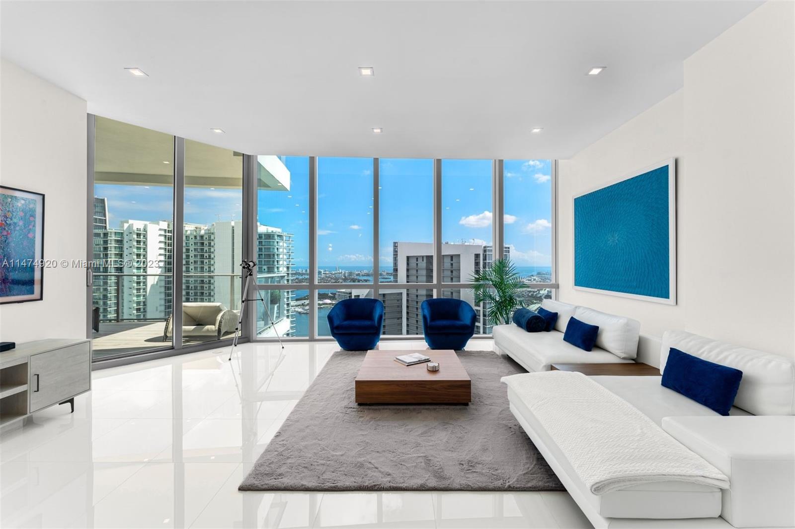 Penthouse 5105 at Paramount Miami Worldcenter is an oversized 1 Bed + Den, 2 Bath condo w/ 1,422 interior sq ft, 11-foot-high ceilings w/ floor-to-ceiling glass windows, white porcelain tiled flooring throughout, motorized shades, dropped ceiling w/ recessed lighting, and spacious terrace w/ views of Biscayne Bay & the Atlantic Ocean from the 51st floor. The den is fully enclosed w/ a closet + plenty of room to accommodate a queen-sized bed. Includes 1 assigned parking space + 1 valet-only space. Building amenities include 5 pools, 2 hot tubs, fitness center, 2 lighted tennis courts, boxing ring, basketball half-court, racquetball court, children's playroom, business center, yoga studios, soccer field, and much more. Over 300,000 sq ft of shops and restaurants at your doorstep.