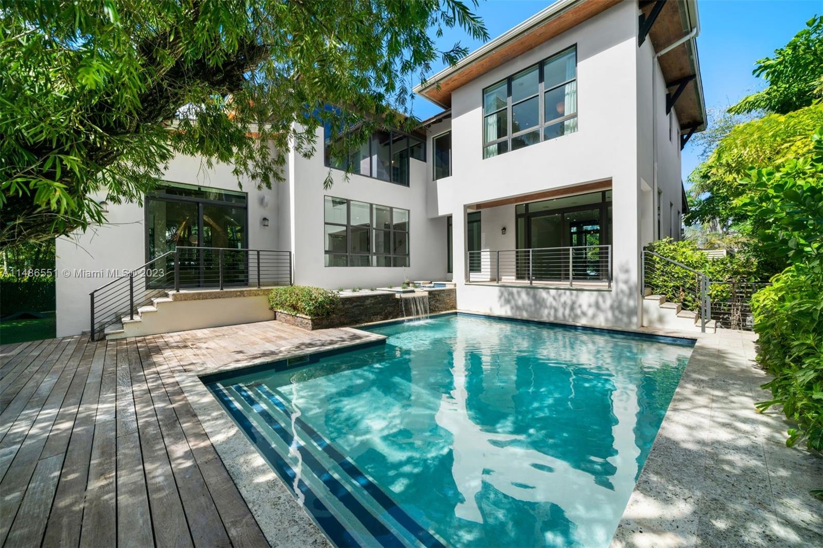 Enjoy living in this private oasis on the highly sought-after island of Key Biscayne. This 5 BD, 5.5 BA residence offers 4,871 SF of modern elegance. Upon entry, one is greeted by double-height ceilings and exposed wood beams. The open floor plan features terrazzo and wood floors, impact windows and doors, and a sleek contemporary design. A gourmet kitchen boasts premium appliances, center island, wet bar, and custom floor-to-ceiling cabinetry. The sizable principal suite offers views of the backyard and a spa-like bathroom. Manicured landscaping surrounds the pool, jacuzzi, expansive terrace, and summer kitchen. Experience the epitome of island living, with convenient access to schools, parks, community center, restaurants & beaches. Also available for rent.