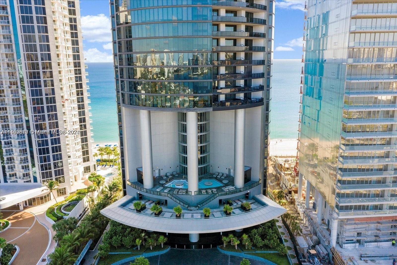 *** Huge price reduction*** presents an opportunity, due to move to another continent, seller is willing and ready to sell!!!!  Two story oceanfront condo at Porsche Design Tower! 3 bed /4.5 bath Home-in-the-Sky with 2-car Sky Garage With Private Car Elevator so you can safely get into your 50th floor home in complete privacy. Dramatic 21 ft ceilings, gorgeous south west views, extensive living area & a grand terrace complete the package. Porsche Design amenities include racing car & golf simulators, full-service restaurant, bar, room service, spa, sunrise and sunset pools & 200 ft on the ocean with beach service.