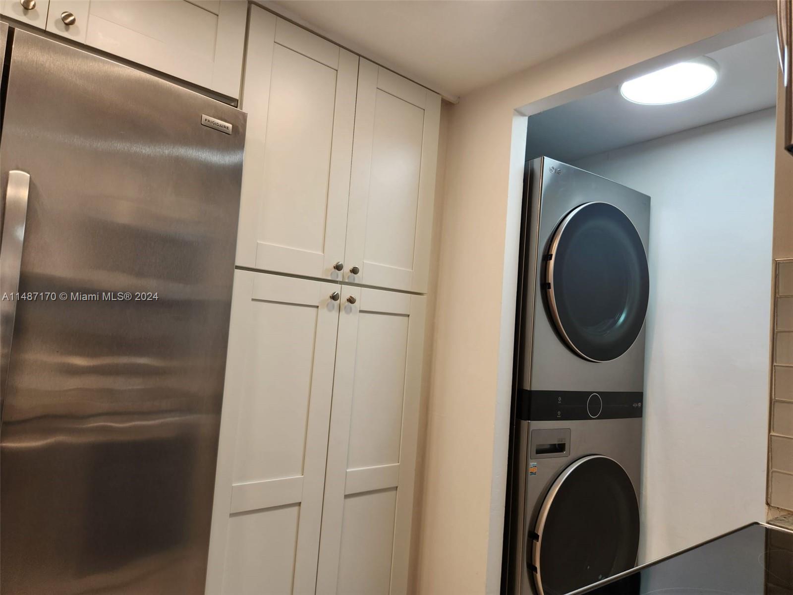 Closer look to the laundry area with front load washer and dryer.