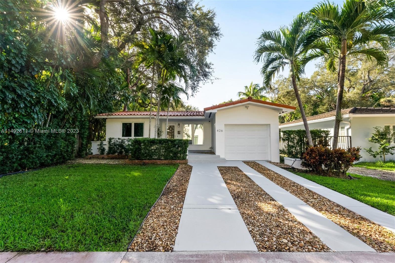 This beautifully renovated South Gables home boasts modern upgrades and classic charm. It features new porcelain flooring with a wood-like finish, an open kitchen with a large Statuario marble island, and a herringbone backsplash. The master suite includes a walk-in closet with a built-in makeup vanity. Outdoors, there is a deck with a pergola and string lighting. Upgrades include new appliances, a wine cooler, a downdraft vent, and LED accent lighting. The home is equipped with smart home technology, smart switches, IP cameras, impact windows, and doors for security and efficiency. A small park is located just four lots over, and it's minutes from Merrick Park, offering a prime, central Coral Gables location.
