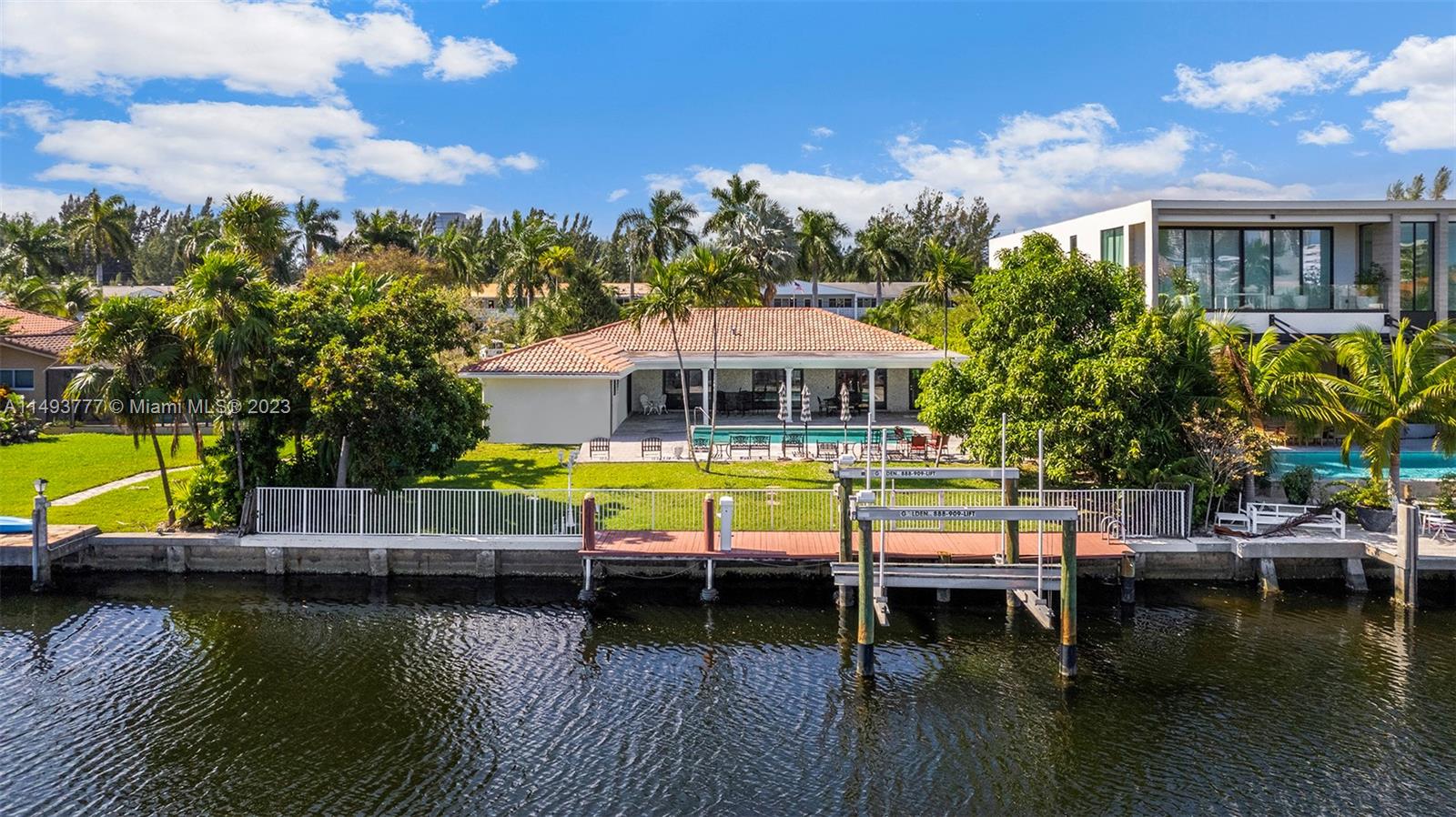 Nestled within the gated waterfront Golden Isles community, this single-story waterfront abode boasts 3 bedrooms, 2.5 bathrooms, and a sprawling backyard. The lots size is 84' x 150', with 84' of waterfront/dockage with a private pool, a convenient boat dock, and a covered terrace featuring a summer kitchen, it's an entertainer's dream. Enjoy seamless indoor-outdoor living in a gated community that offers easy access to both Miami and Fort Lauderdale. Perfect for boating enthusiasts, this home ensures effortless ocean access with no fixed bridges, deep water and wide canal. Golden Isles has embarked on a series of enhancements, plans underway to resurface streets by March 2024. Additionally, a vision plan has been devised for the future growth of this prestigious gated community.