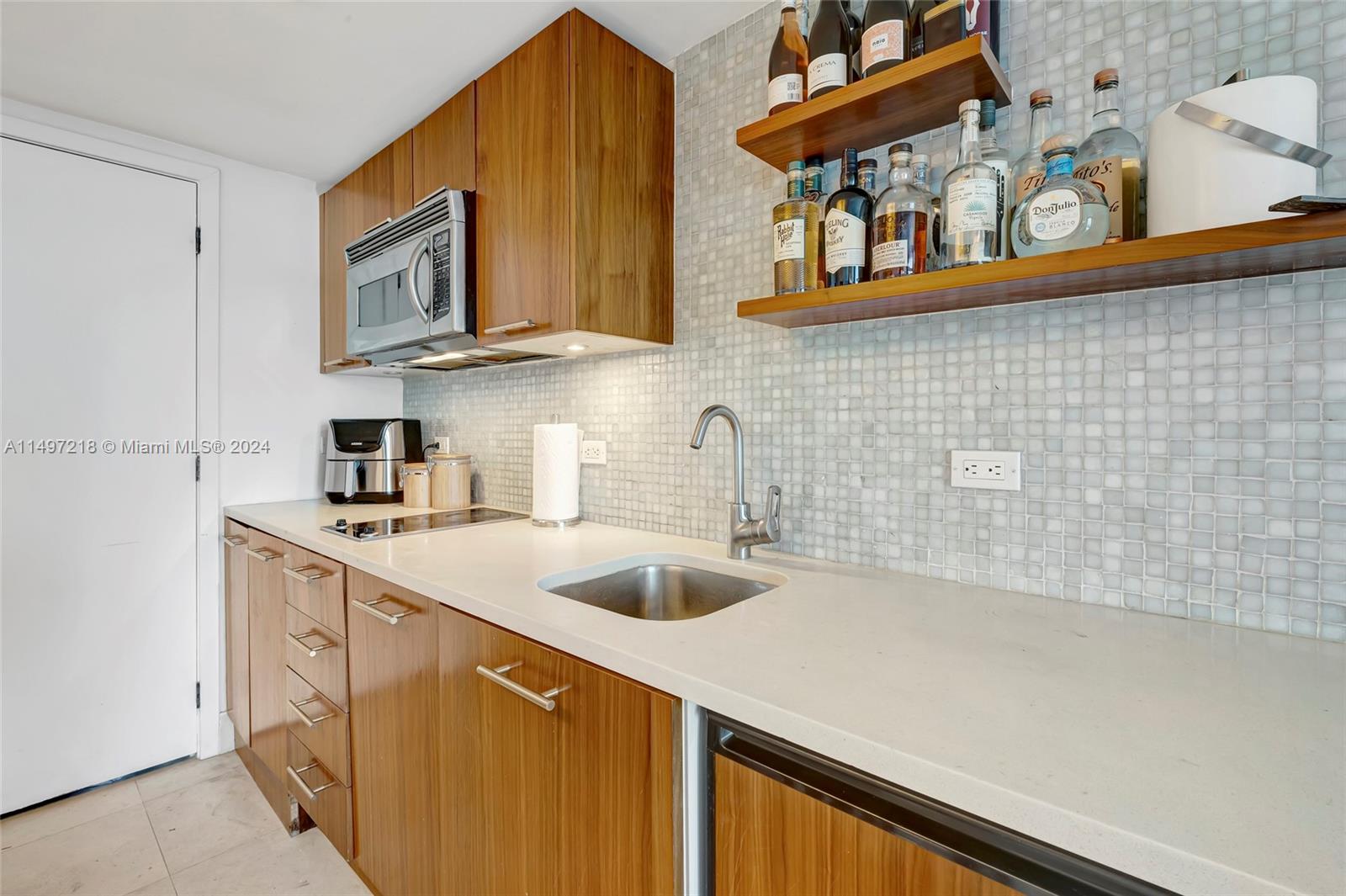 Beautiful seaglass backsplash, a nod to the beautiful sea in your seaside tropical retreat.