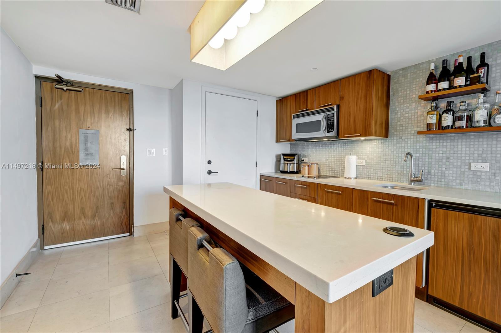 Modern solid countertops and island in kitchen.