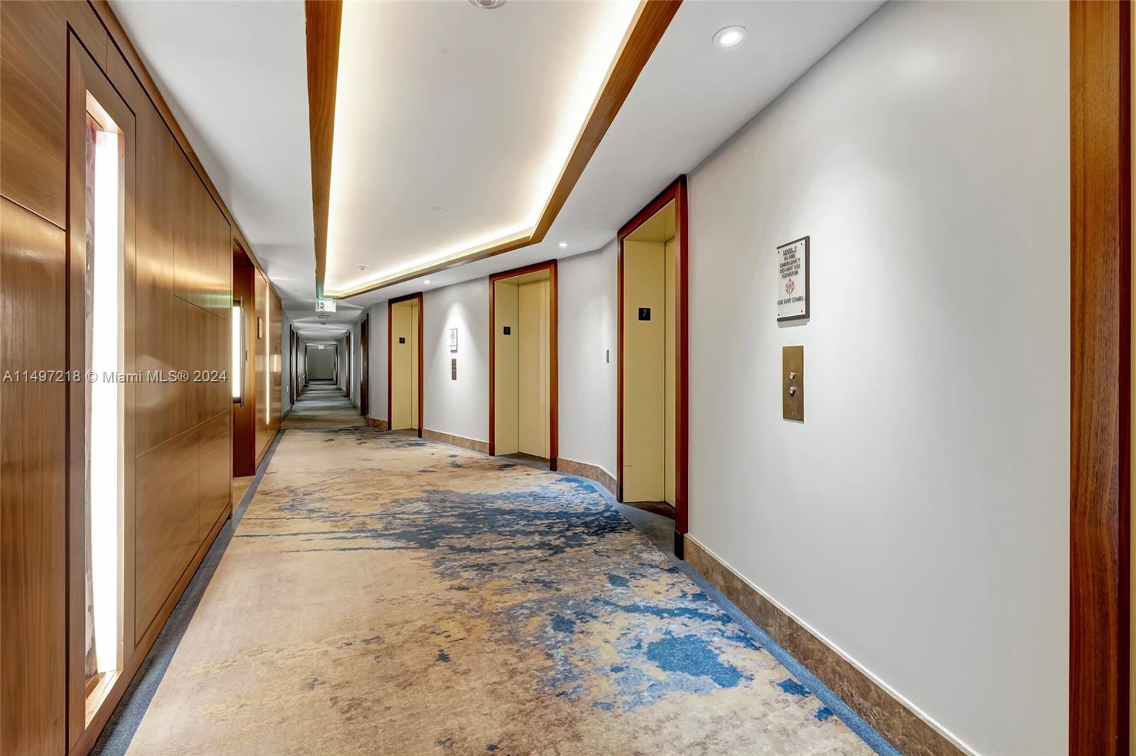 Hallways are tastefully adorned with warm natural woods, glass and coastal-inspired carpeting with a nod to the seashore  below.