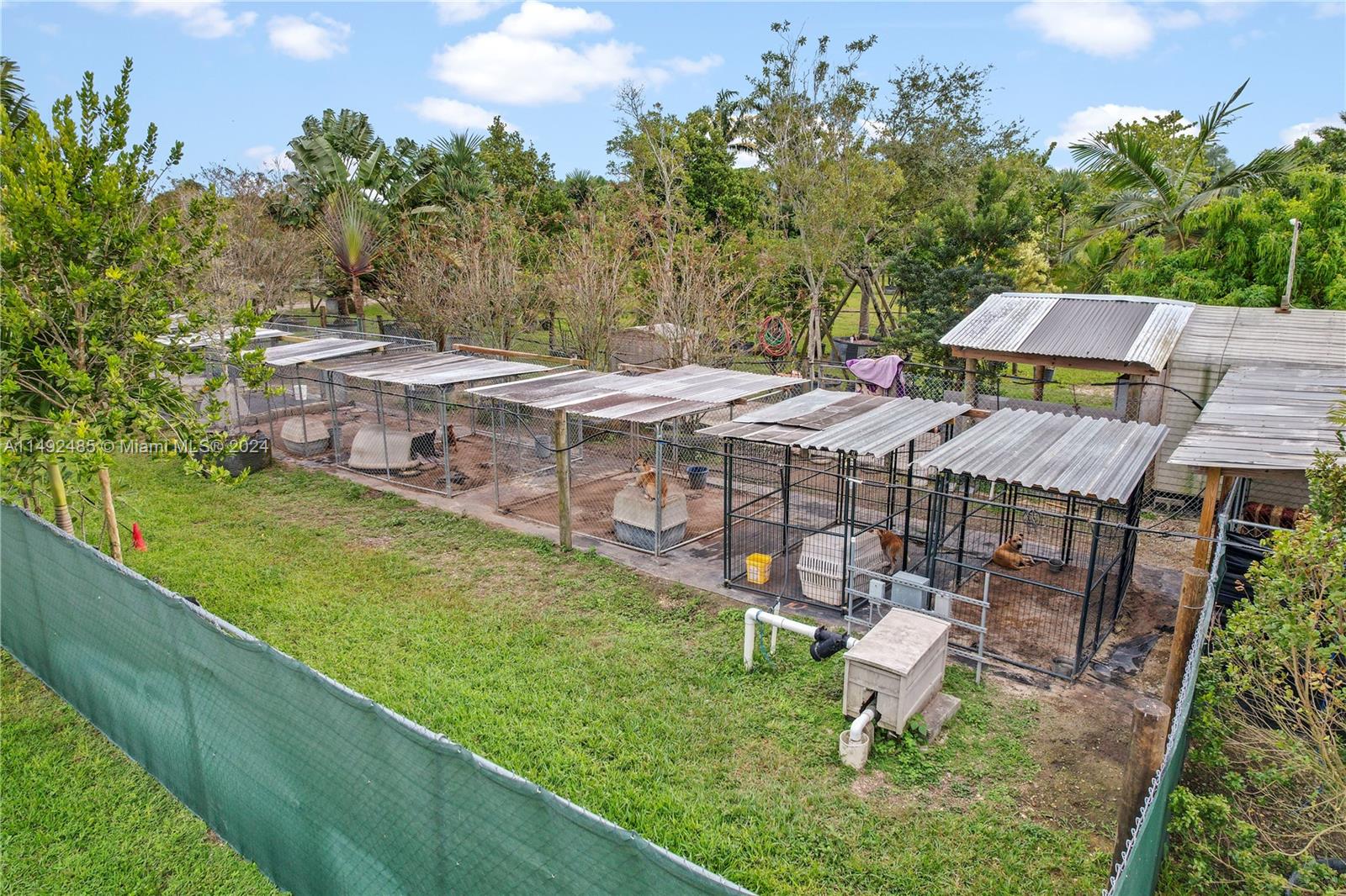 KENNELS... WITH IRRIGATION PUMP, ALL KENNELS STAY BUT 2 PORTABLE ONES SEEN IN SHOT