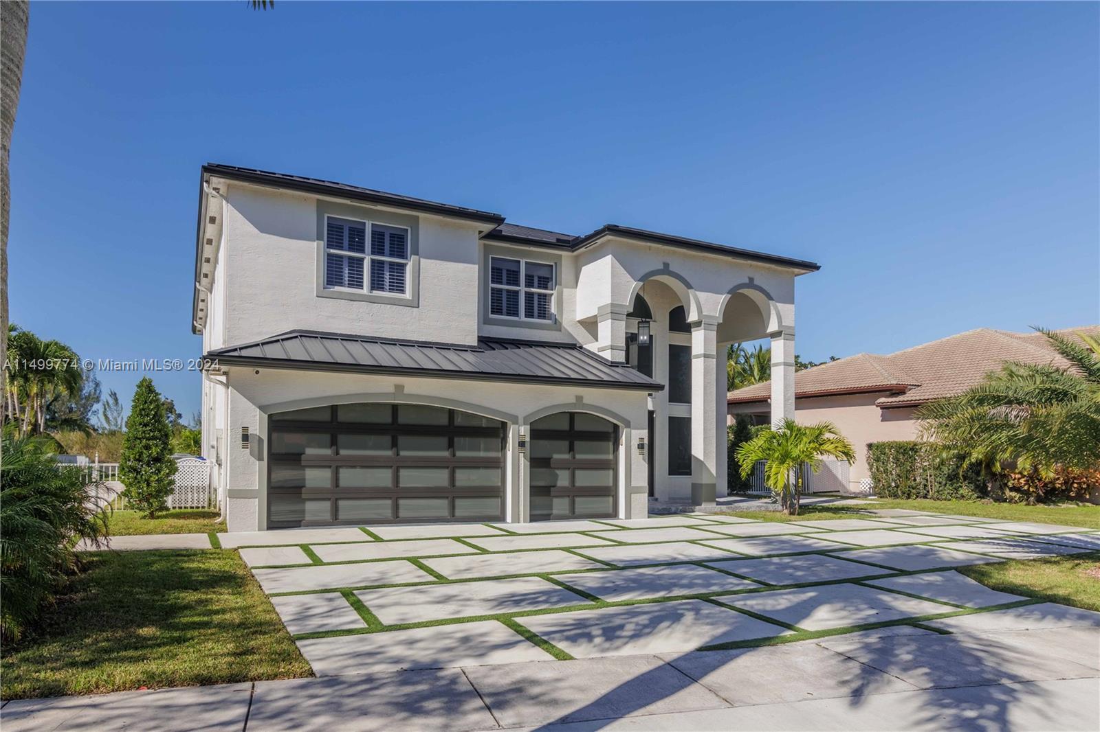 At the entrance, you'll be greeted by a striking sight – a triple wooden garage with high-quality impact-resistant glass. This garage not only provides ample parking space but also adds a touch of sophistication and durability to the propertyThe combination of wood and impact-resistant glass not only adds an elegant and modern touch to the property but also reflects the commitment to both aesthetics and functionality. It's a testament to the thoughtful design and high-quality materials used in this beautifu