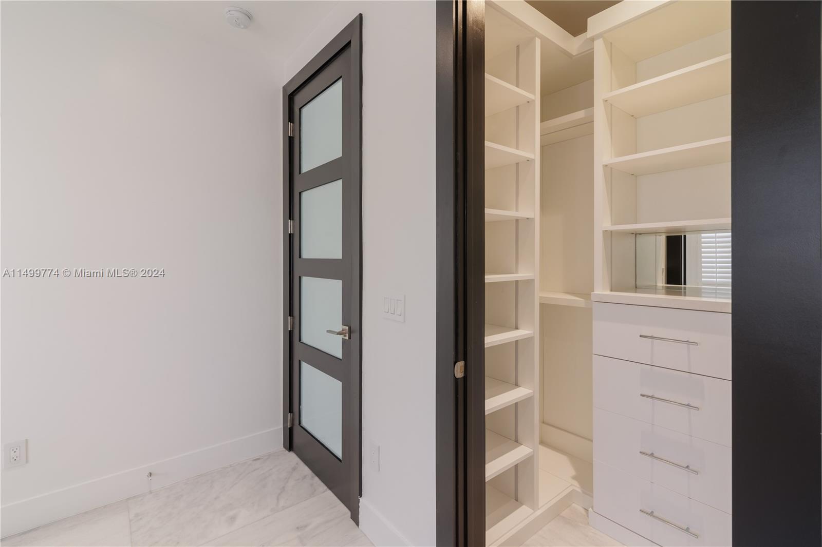 A wooden closet is  spacious and designed to make the most of the available space.