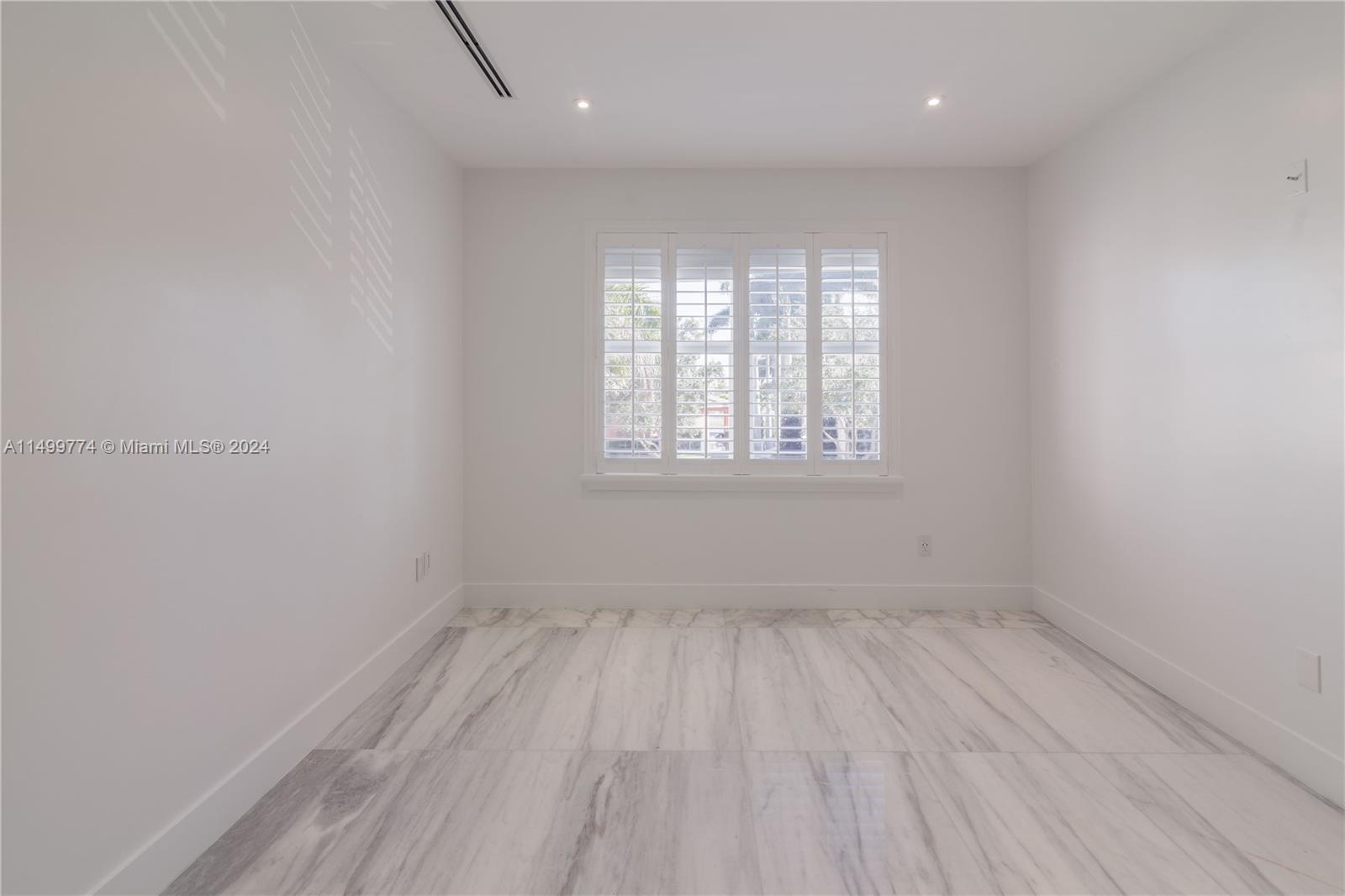  This room with its closet and window is a versatile part of the house that combines functionality .