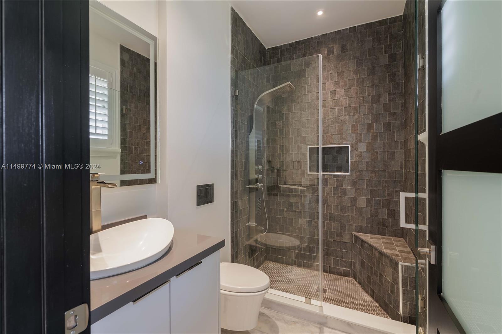 This bathroom features a separate shower stall instead of a bathtub. The shower may be equipped with a glass enclosure or a curtain to contain water and ensure comfort during bathing.