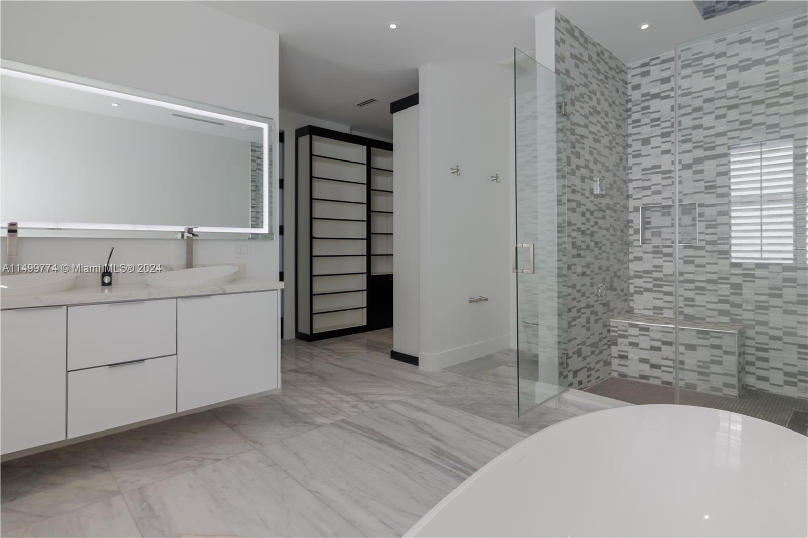 This spacious master bathroom exudes unparalleled elegance with high-quality finishes and meticulous attention to detail.