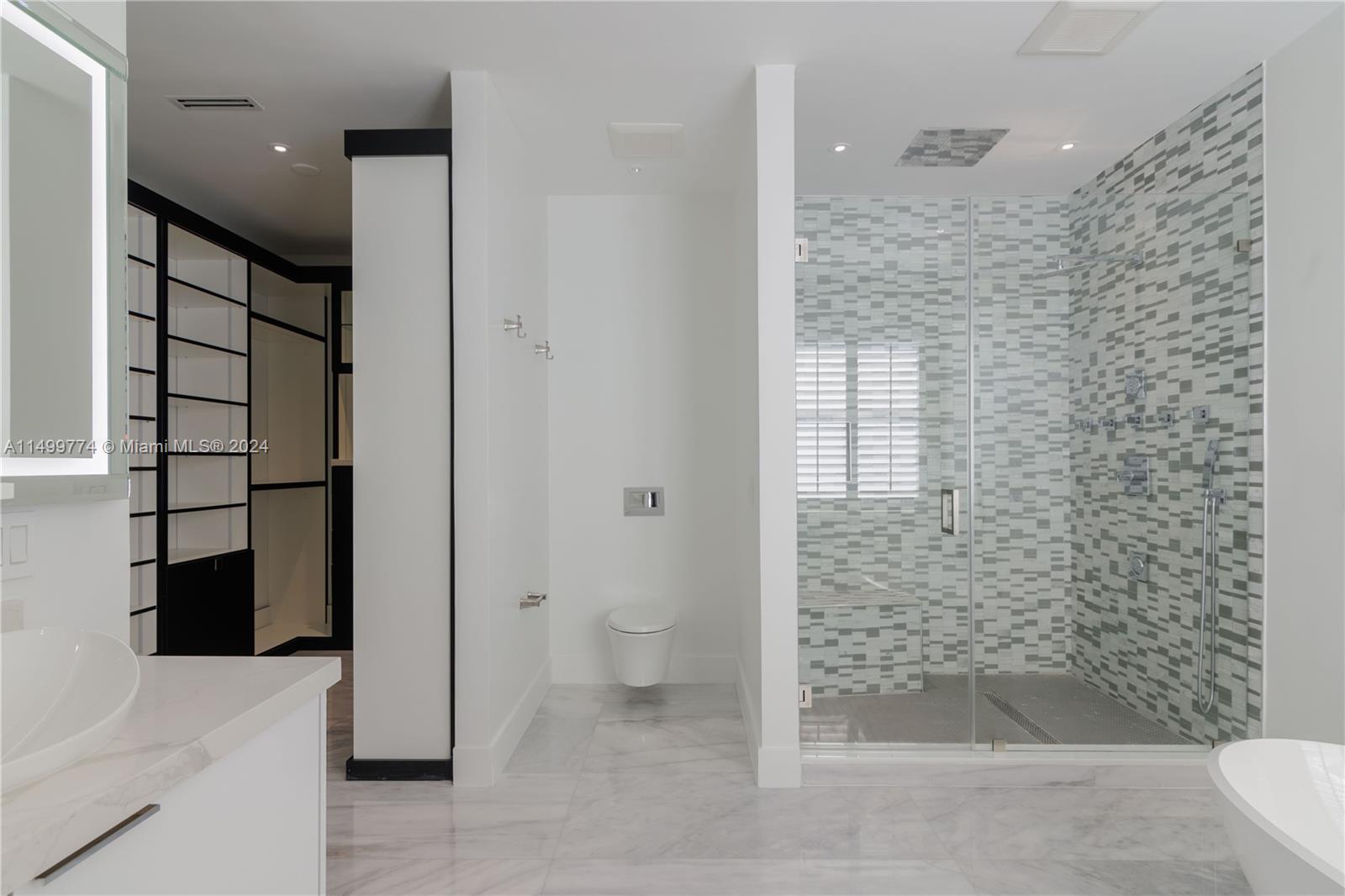 The shower is a luxury masterpiece with multiple showerheads, temperature options,. Mosaic finishes and high-quality fixtures complete the bathing experience.