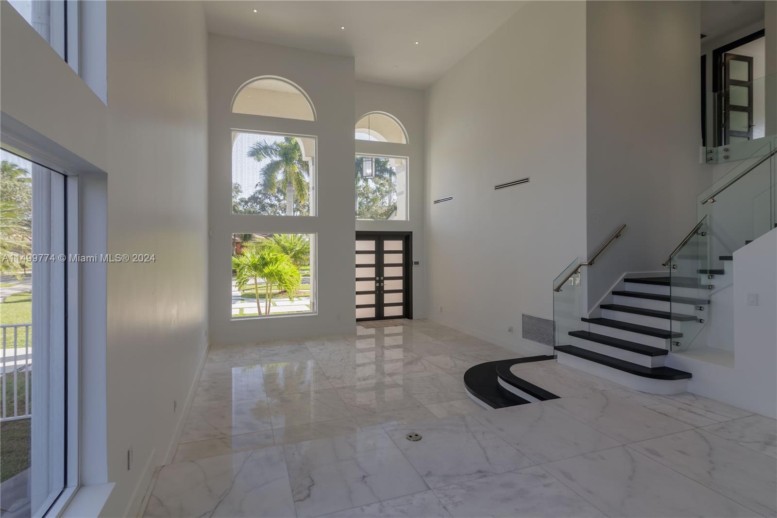 The living room in this house is a spacious and inviting area that seamlessly connects to the kitchen. It's designed to be a central hub for relaxation and socializing, offering both comfort and style