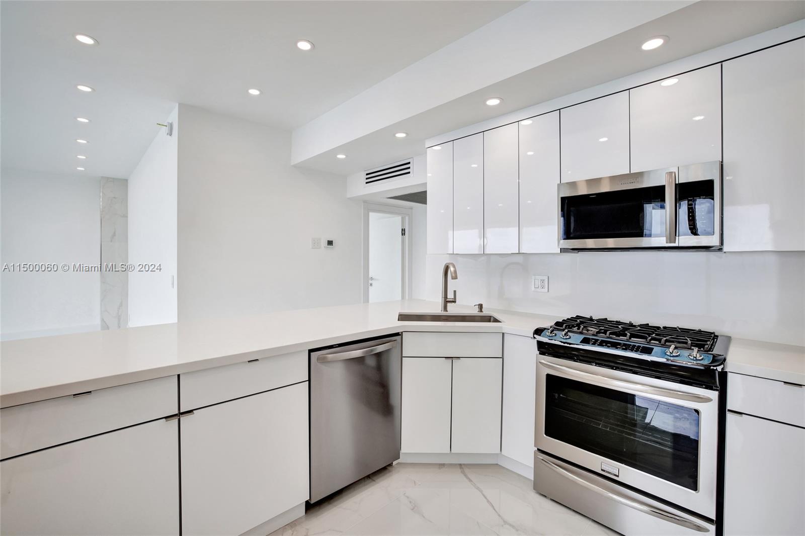 OPEN FORM KITCHEN OFFERS SERVE-THROUGH SOLID QUARTZ SERVICE COUNTER & BACKSPLASH, STAINLESS STEEL SINK, APPLIANCES ,NATURAL GAS OVEN,CUSTOM LIGHTING AND 9 FT HIGH VOLUME CEILINGS