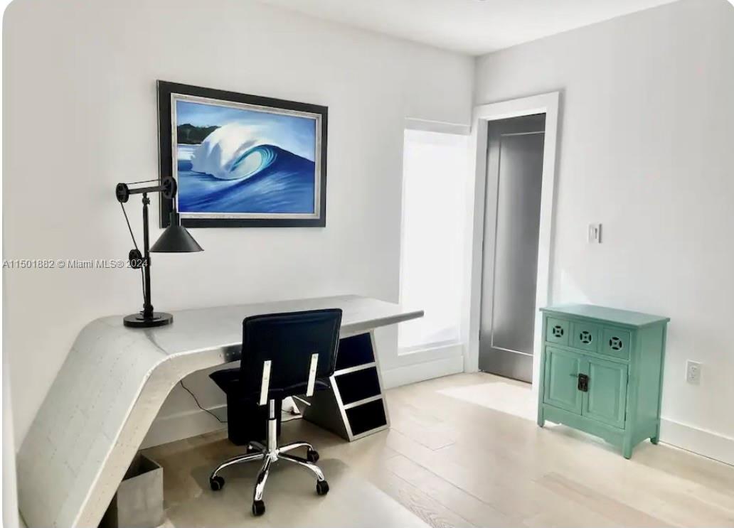 office with a walk-in closet and full bathroom