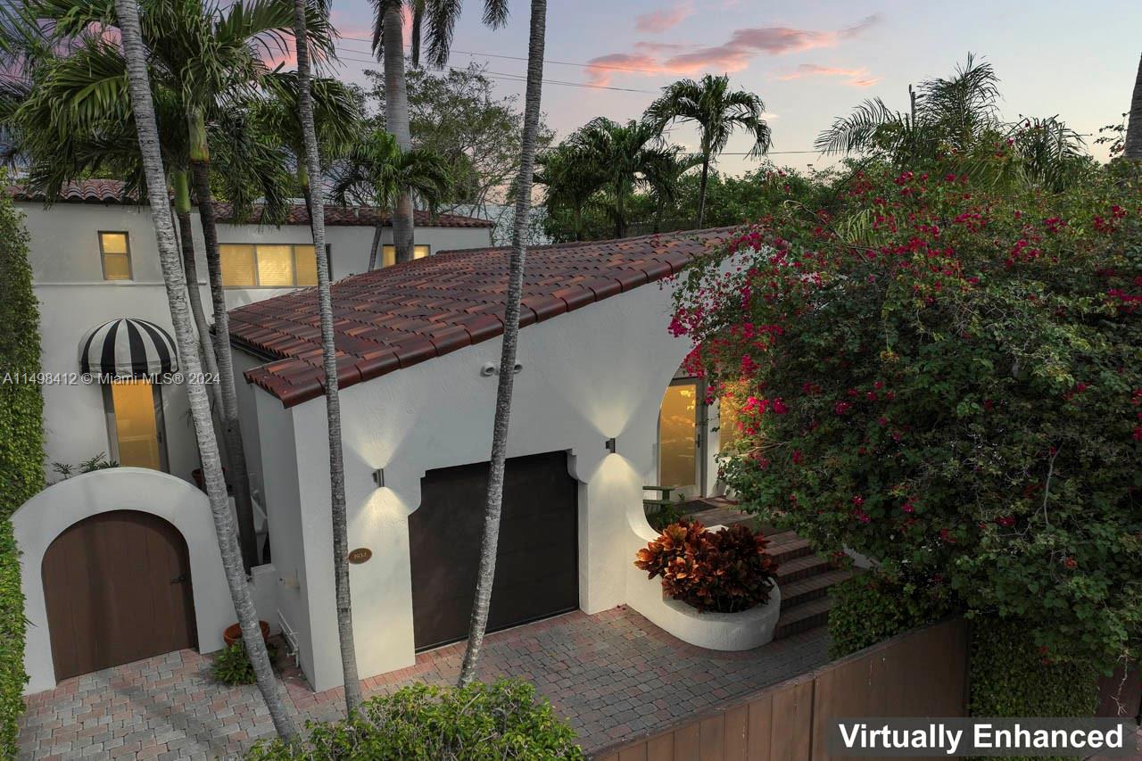 Welcome to 729 Espanola Way a true Miami Beach landmark designed by architect V. H. Nellenbogen. Mediterranean villa with flawless interior & luxurious finishes. House & connected large guest house within the compound (zoned multi-family). The grand main house w/spectacular appeal, soaring cathedral vaulted ceilings, decorative fireplace, wood floors, impact windows & doors features 2 bedrooms, spa baths & custom kitchen with gas cooking and stunning custom cabinetry. Living/dining lead to the patio and coveted garage. Guest house (2/2) town-house style, with foyer, winding staircase and bedrooms with ensuite baths. Modern kitchen, laundry and sublime foyer. Mid-century modern feel framed by lush tropical landscape and private garden. Privacy & style on the coveted Espanola Way.