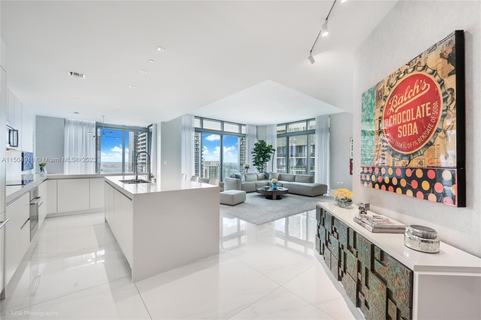 Stunning corner 4BR/4.5BA lower penthouse unit offering breathtaking panoramic water and skyline views from sunrise to sunset in the elegant Rise building adjacent to Brickell City Center Mall. 12' ceilings with 48"x48' white Italian porcelain floors throughout the unit and other upgrades recently completed in 2022. Custom Italian finishes throughout the apartment. Large wraparound 9ft deep balconies offering 360-degree views. Walk-in closets in every bedroom featuring Italian cabinetry. Electrical window treatments and white custom shades. Quartz counter kitchen tops with waterfall island and floating cabinetry in bathrooms. Large laundry room w/ additional storage and maid's room w/bathroom. The unit includes 2 parking spaces and free valet service for visitors.