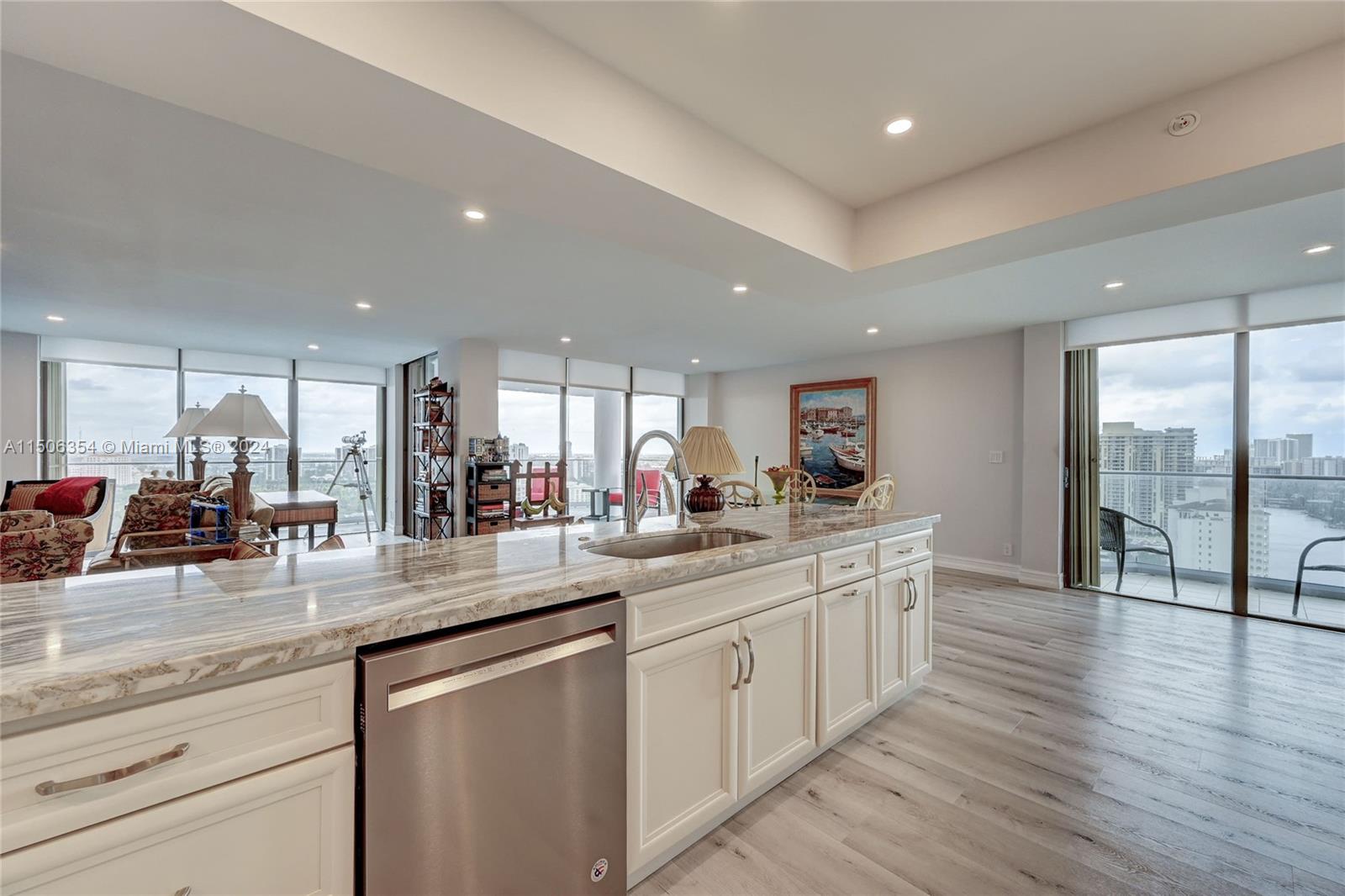 OPEN CONCEPT KITCHEN WITH PATIO DOORS TO BALCONY