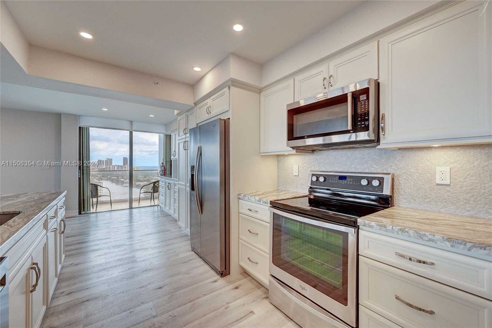 OPEN CONCEPT KITCHEN WITH PATIO DOORS TO BALCONY