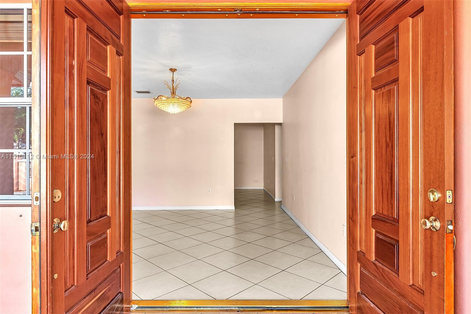 Wide Doble Doors open to the Formal Living room.