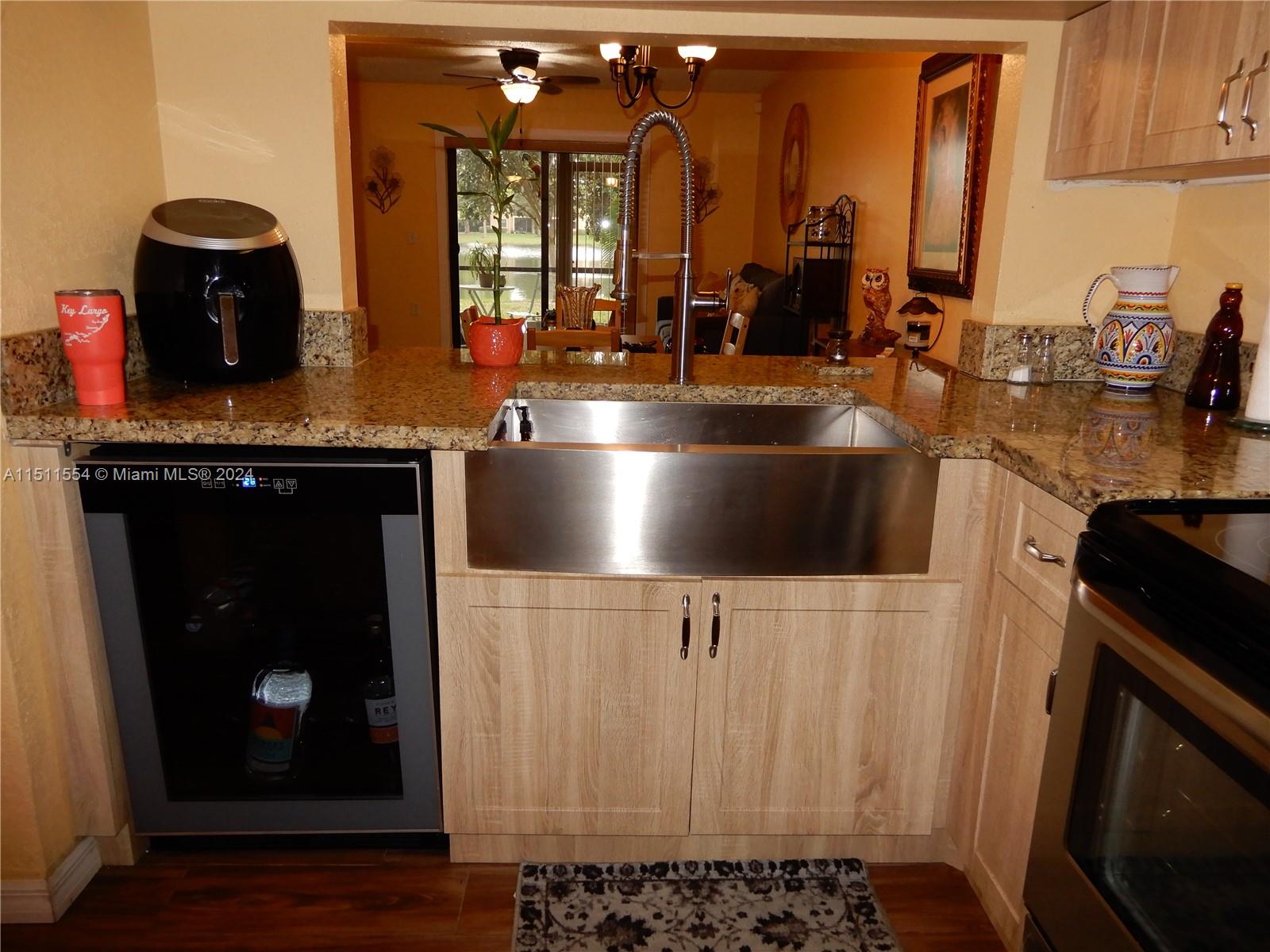 Large farm-style sink, wine cooler in dishwasher spot.