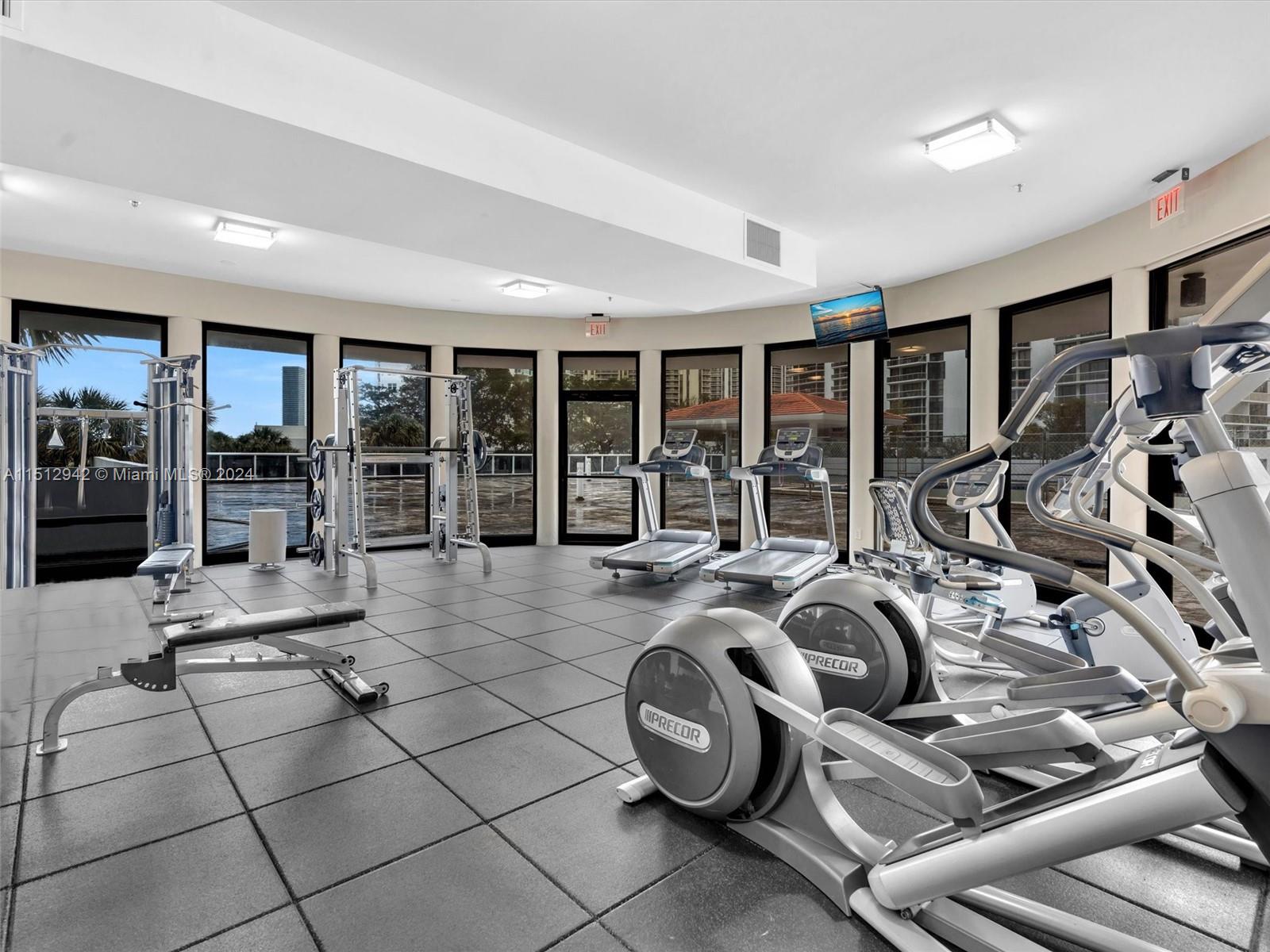Gym overlooks and open to the pool deck area.