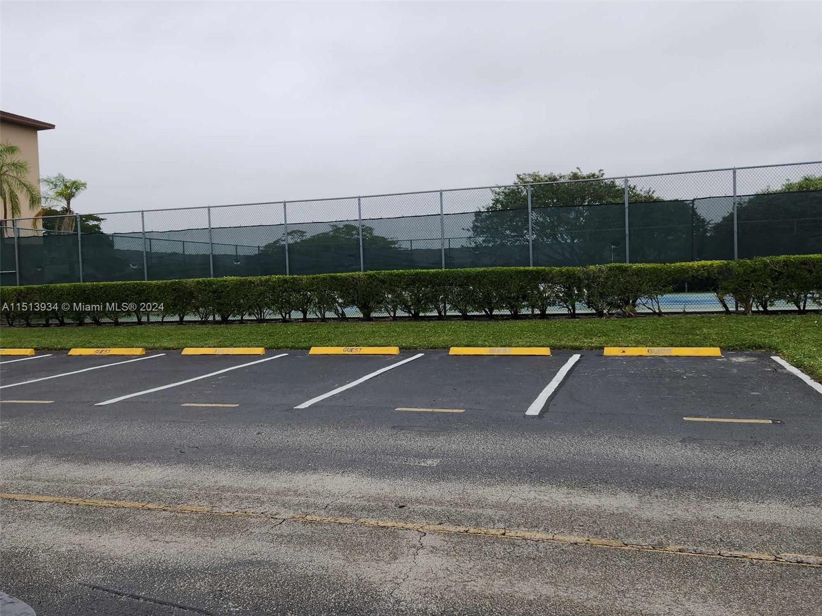 Tennis court next door to building with ample guest parking.