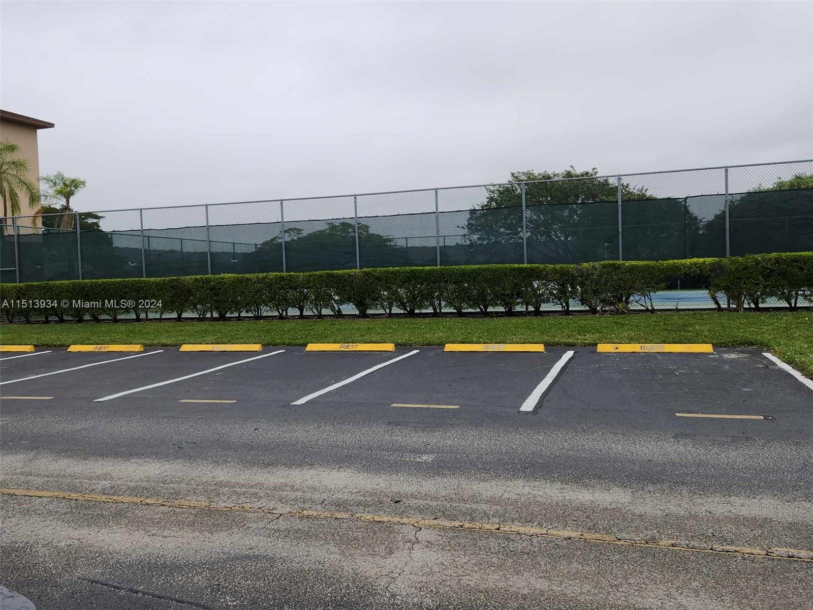 Tennis court next door to building with ample guest parking.