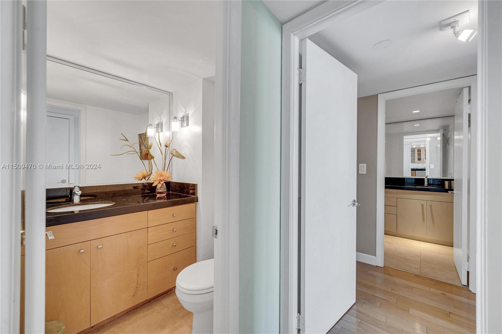 half bath leading into primary bedroom