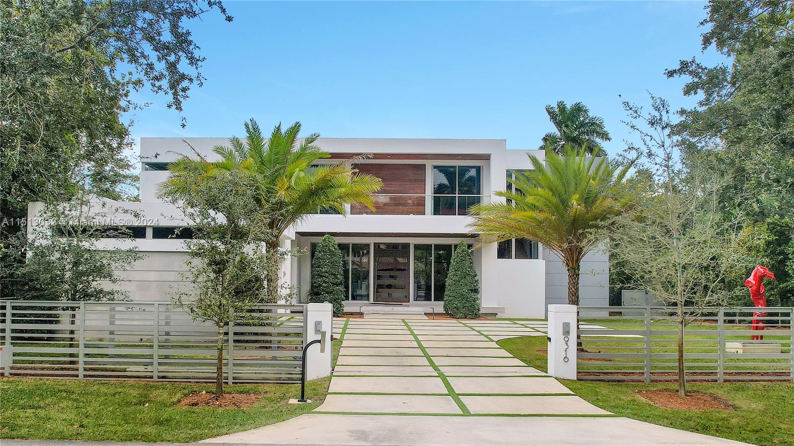 Prime North Pinecrest location on a 16,003 sq ft lot! This exquisite high-end property, aprox 6,228 Sq.Ft (adjusted) is the epitome of luxury living in SoFlo. Constructed in 2022, this modern home features top-of-the-line finishes that radiate sophistication. Includes a state-of-the-art swimming pool, equipped with a powerful turbine for counter-current swimming, perfect for fitness enthusiasts or those seeking relaxation! Additionally, the residence includes a dual electric vehicle charging setup, marble floors, sub-zero/wolf appliances, RH chandeliers, advanced high-definition Lutron sound system provides an unparalleled auditory experience, projector with retractable cinema screen, custom cabinets and closets and much more. Near shopping and dining. **Red sculpture is not included.