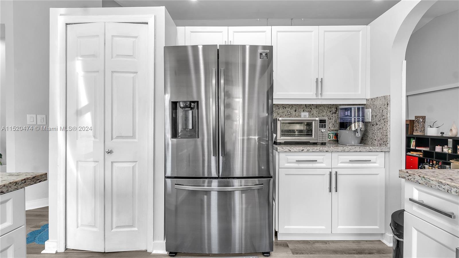 white shaker cabinets with granite counterop with 12 inches handles 
