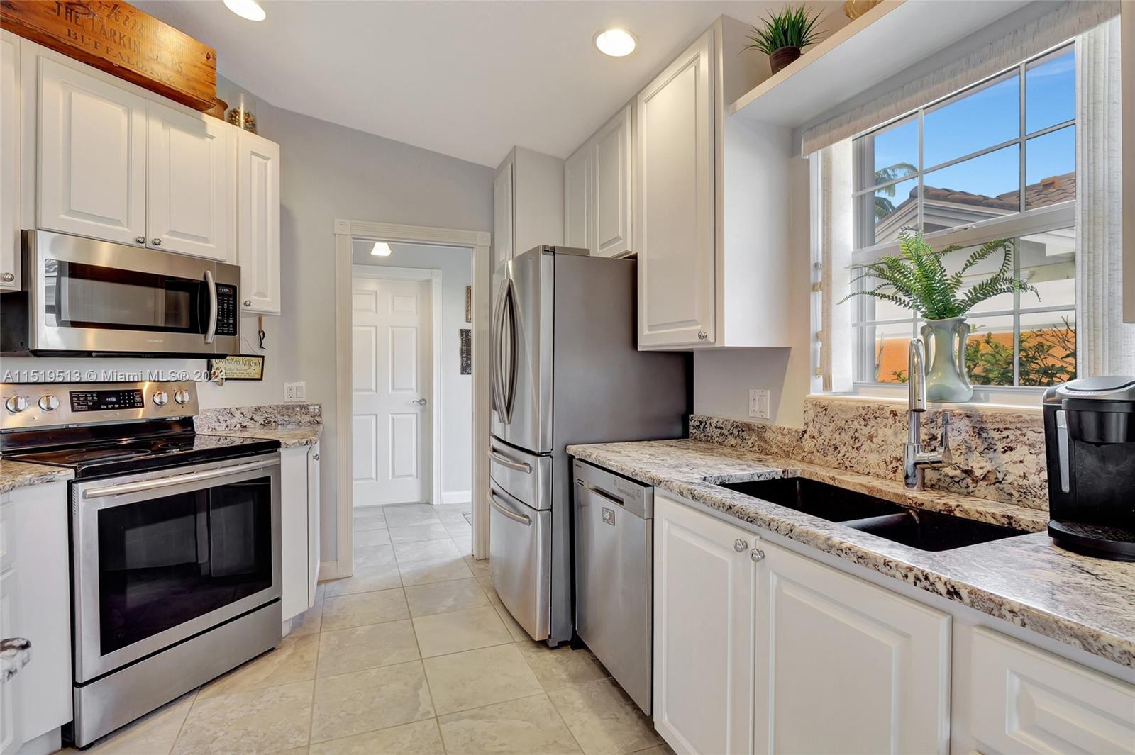 Alt view of kitchen with access to foyer & door to laundry room