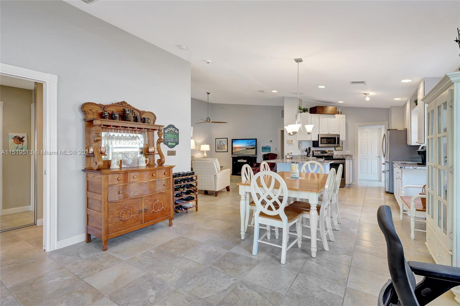 Alt view of desk/office/den area overlooking dining & also doorway to primary suite