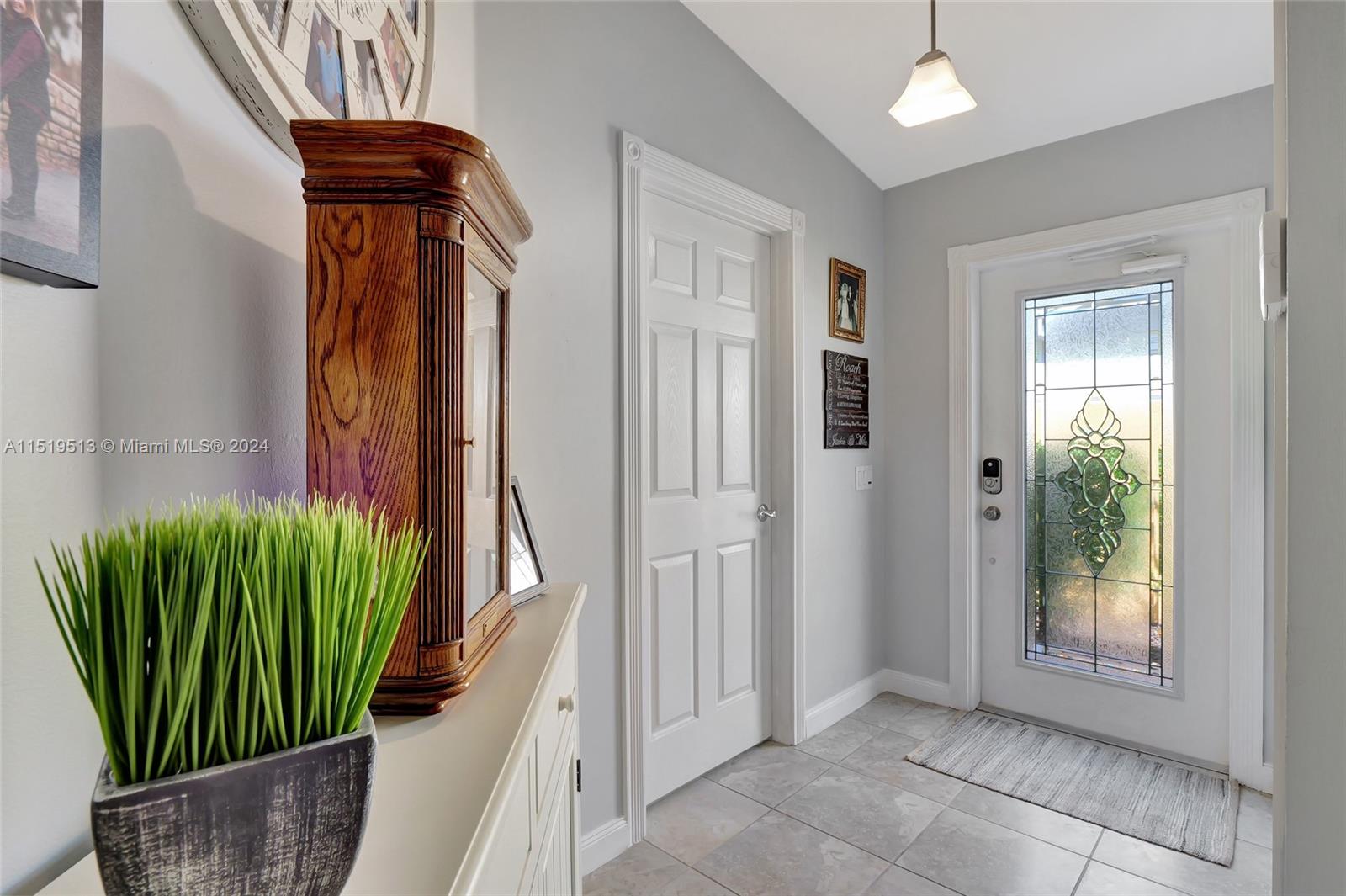 Foyer/main entry area & access to laundry room & garage