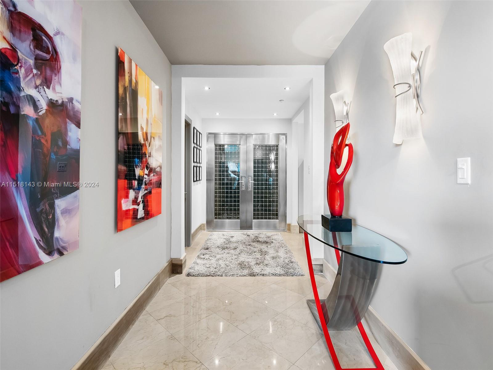 Step off the semi-private elevator through these glass doors