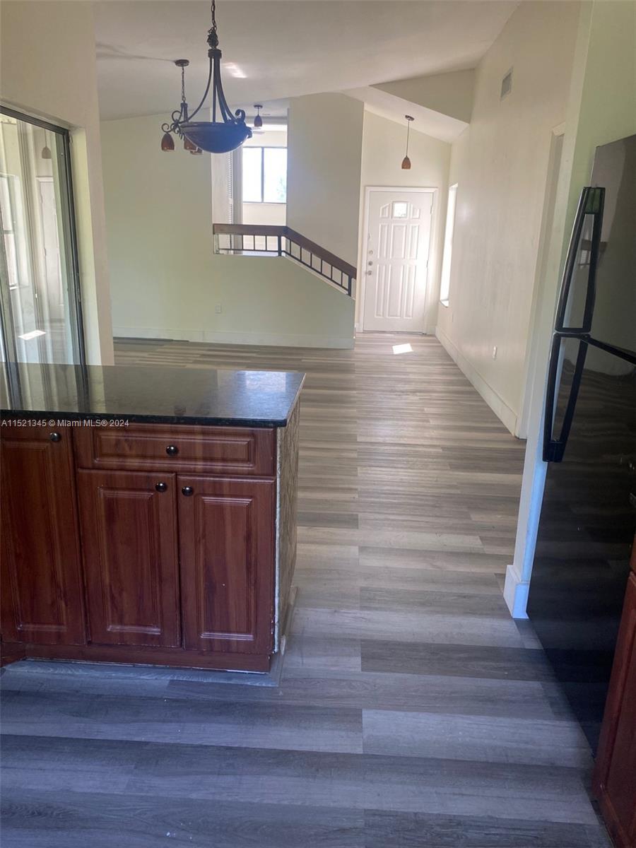 In kitchen looking towards the front door and the guest bedroom up the stairs