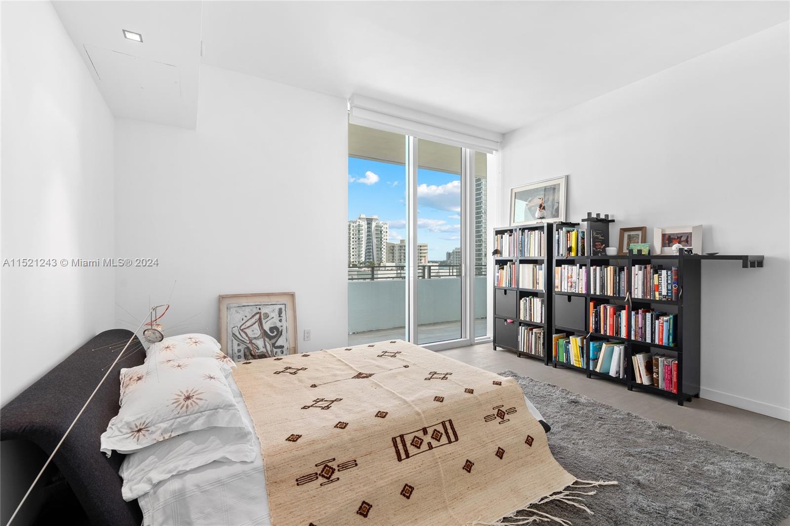 Primary Bedroom suite with access to balcony connected to 980 SF terrace.  A true walk through and around residence.