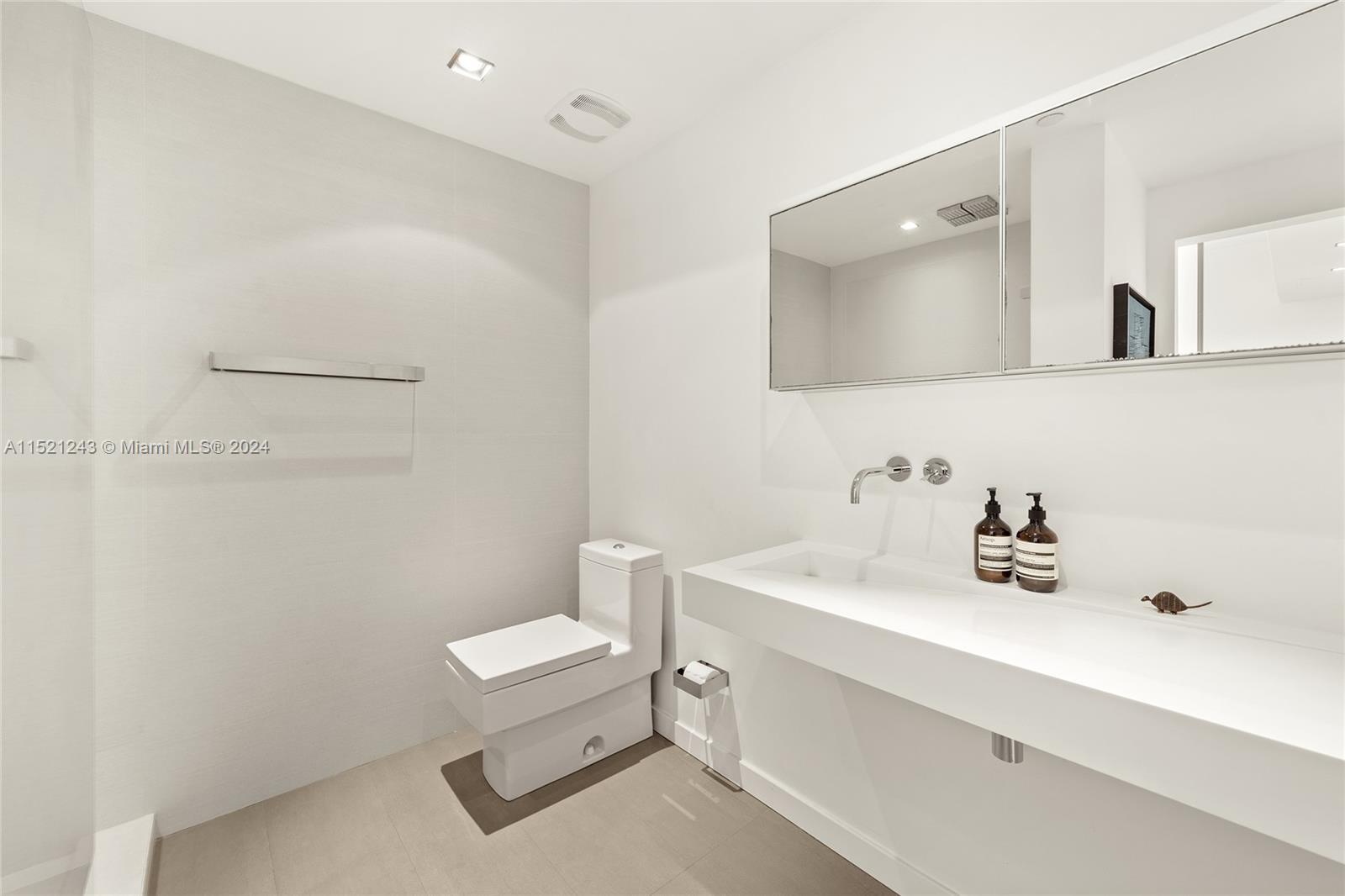 En-suite bath off primary bedroom with Boffi wall mounted bathroom as well as Hansgrohe bathroom faucets.  Shower offers both a rain and hand shower feature.