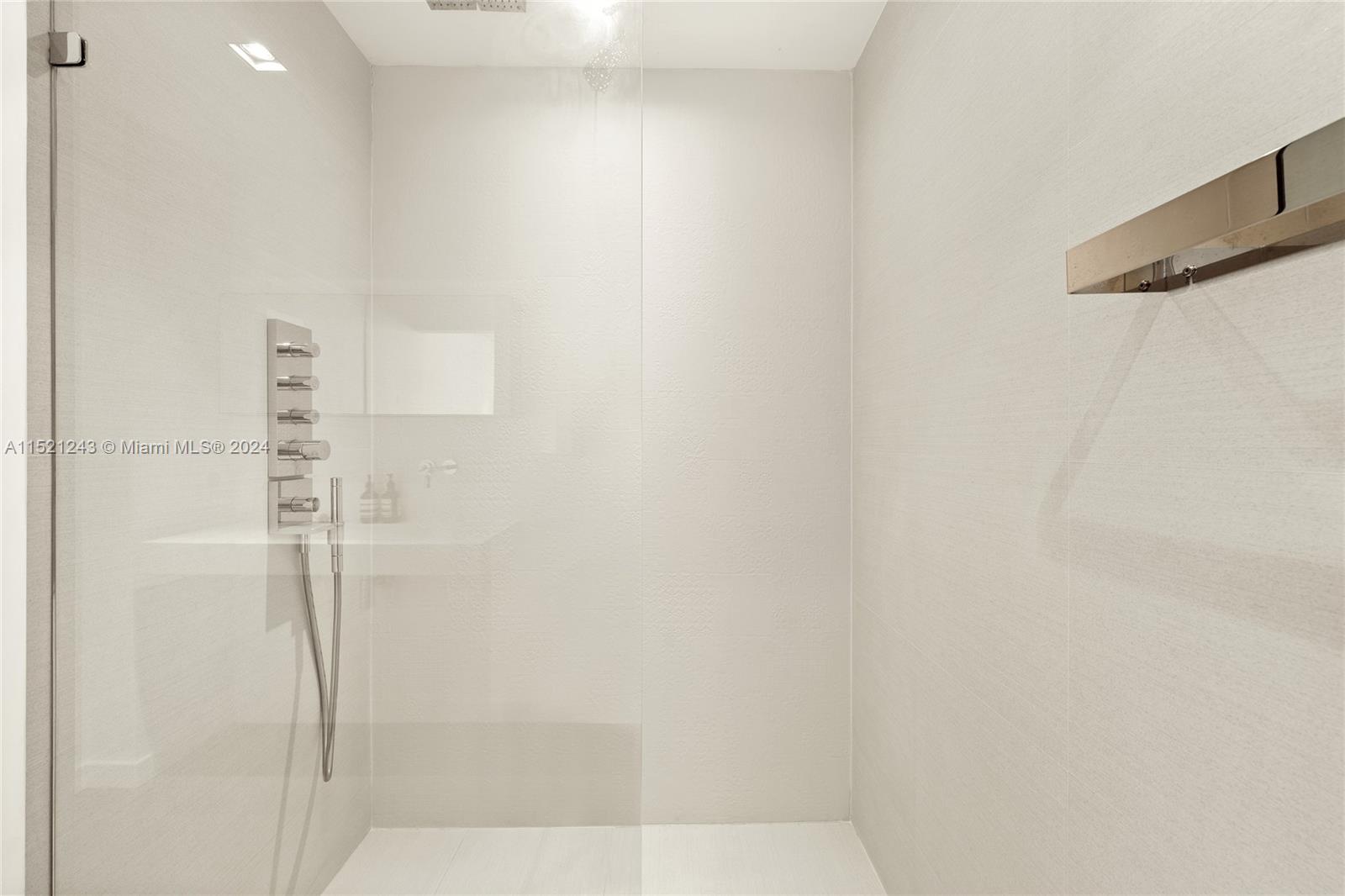 En-suite bath off primary bedroom with Boffi wall mounted bathroom as well as Hansgrohe bathroom faucets.  Shower offers both a rain and hand shower feature.