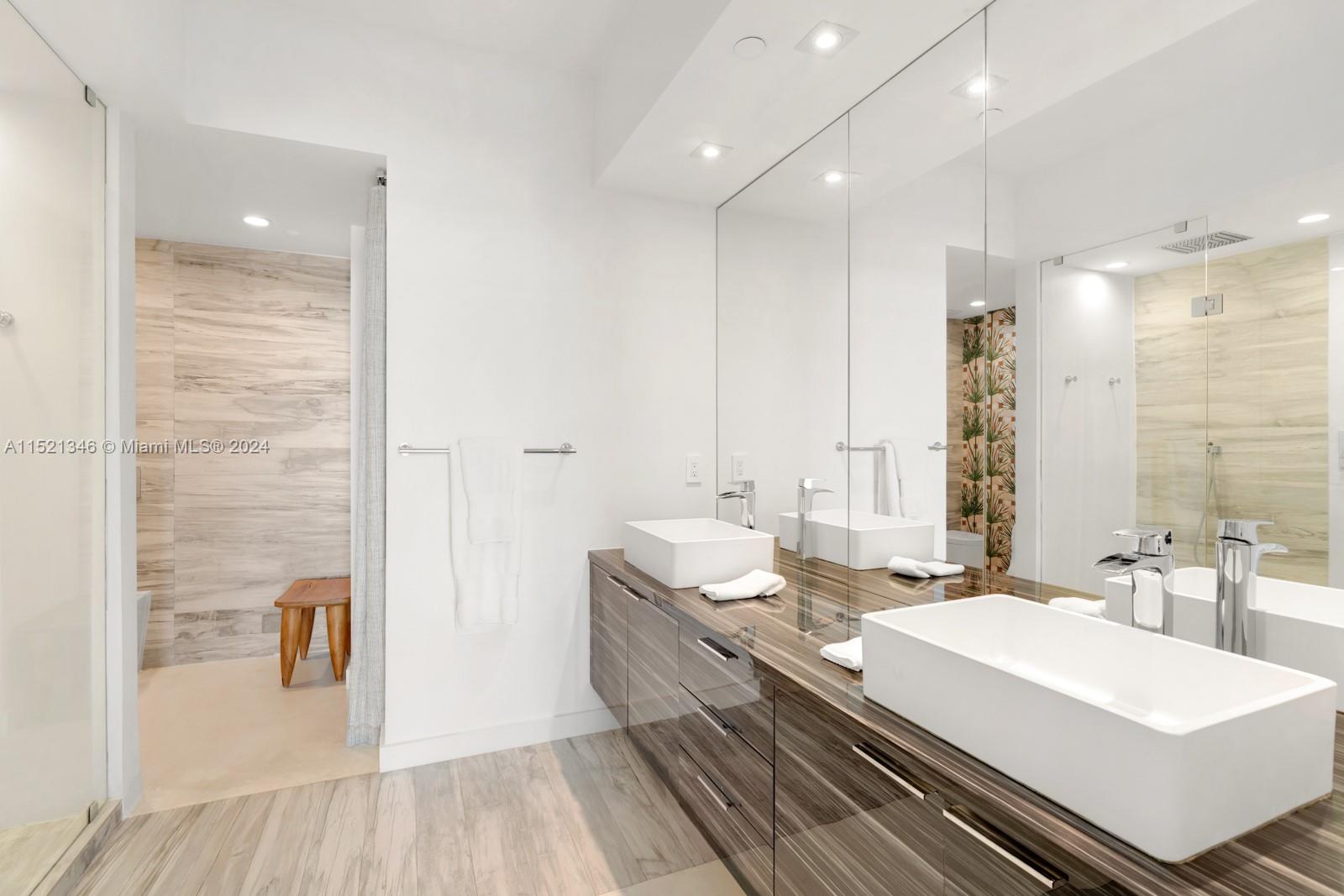 MASTER BATHROOM WITH DOUBLE VANITY, TWO PERSON RAIN SHOWER, TOTO TOILETS, AND ADDITIONAL STORAGE AREA
