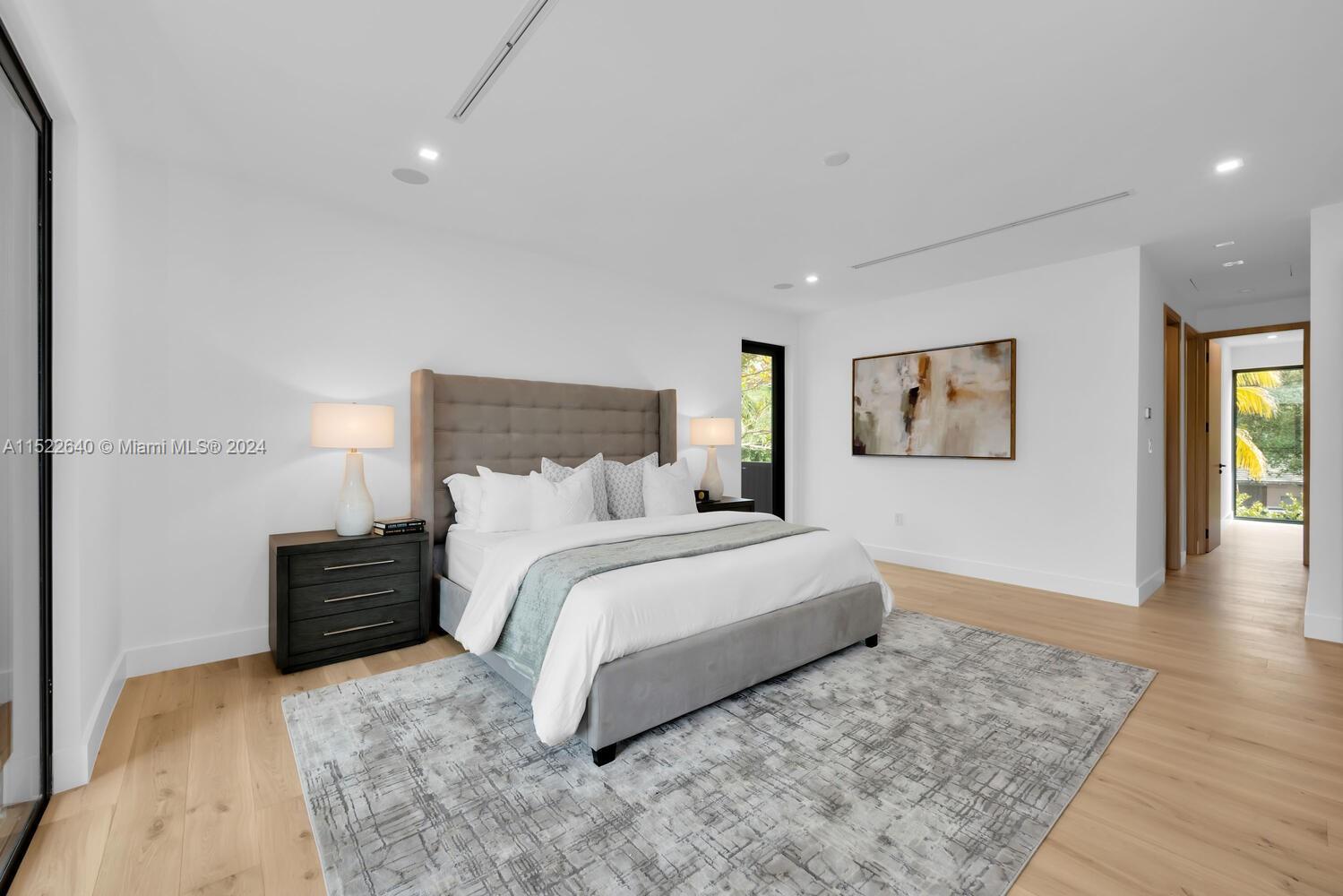 Primary suite hallway to his and hers closet