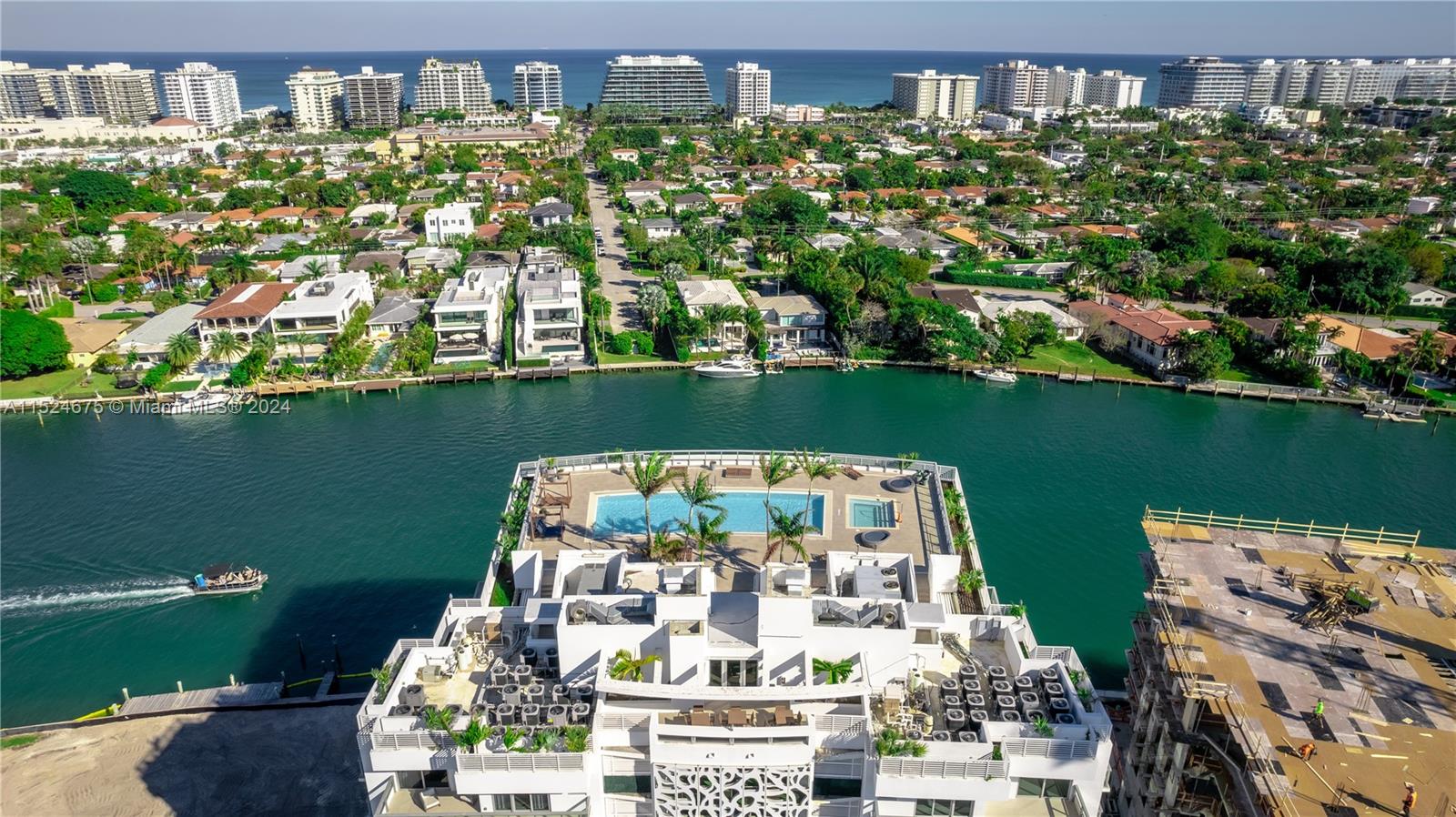 RARE OPPORTUNITY! Luxury fully furnished unit with side water view in the prestigious Bay Harbor Islands. This TURN-KEY RESIDENCE is fully equipped, featuring modern furniture, premium wood tile, and several upgrades. Enjoy a ROOFTOP POOL WITH STUNNING VIEWS. The 2-bed + large den (converted to a 3rd bed) offers 1,305 sqft of living area and nearly 400 sqft of balconies. Situated in ONE OF THE MOST SOUGHT-AFTER AREAS in Greater Miami, very close to Indian Creek, A-rated schools, and just minutes from the beach, Bal Harbour Shops, and trendy restaurants. Includes 2 ASSIGNED PARKING SPACES (a rarity on the island) and storage. New ultra-luxury building (La Baia) under construction on south lot, adding GREAT VALUE to the area. Don't miss out!