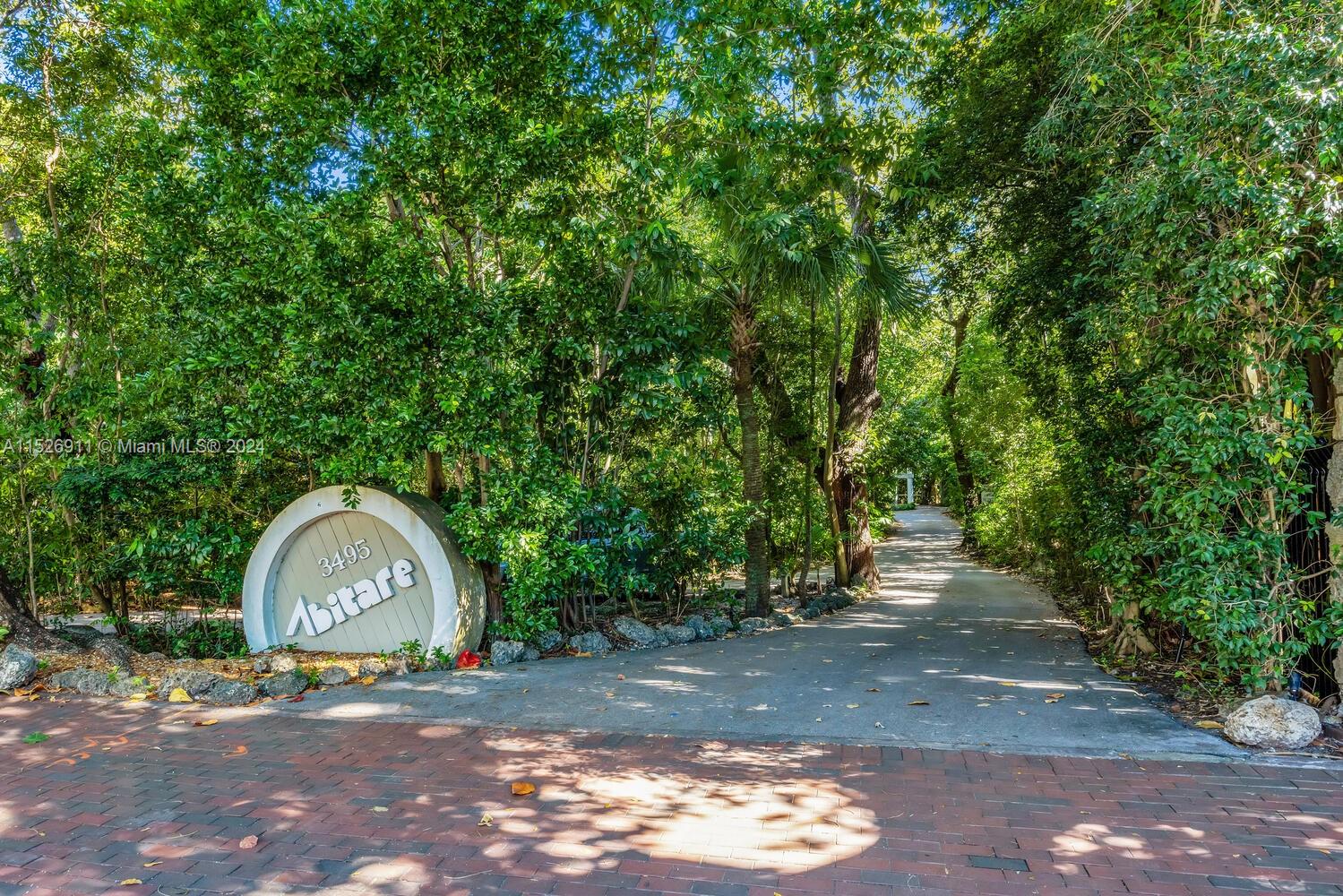 Magical townhome in Abitare, an ultra-private guard-gated community - secluded in a natural hardwood hammock on the shores of Biscayne Bay. Just steps from the historic Coconut Grove village, with it’s galleries, bouitques & cafes. Enter via a winding tree-canopied road to this coastal-style, two-story residence. 2BR/2.5BA. Light-filled living spaces w/25’ wood-beamed ceilings, soaring skylights, fireplace, updated kitchen & wood-plank style tile flooring. 2nd level offers open loft/family room/office + 2 oversized bedrooms w/ high vaulted ceilings & en-suite baths. Enjoy bay breezes from a charming screened porch & rooftop terrace overlooking the tree-tops. The community offers a tropical pool & private dock w/ slips offering direct ocean access (35x25) available to each resident.