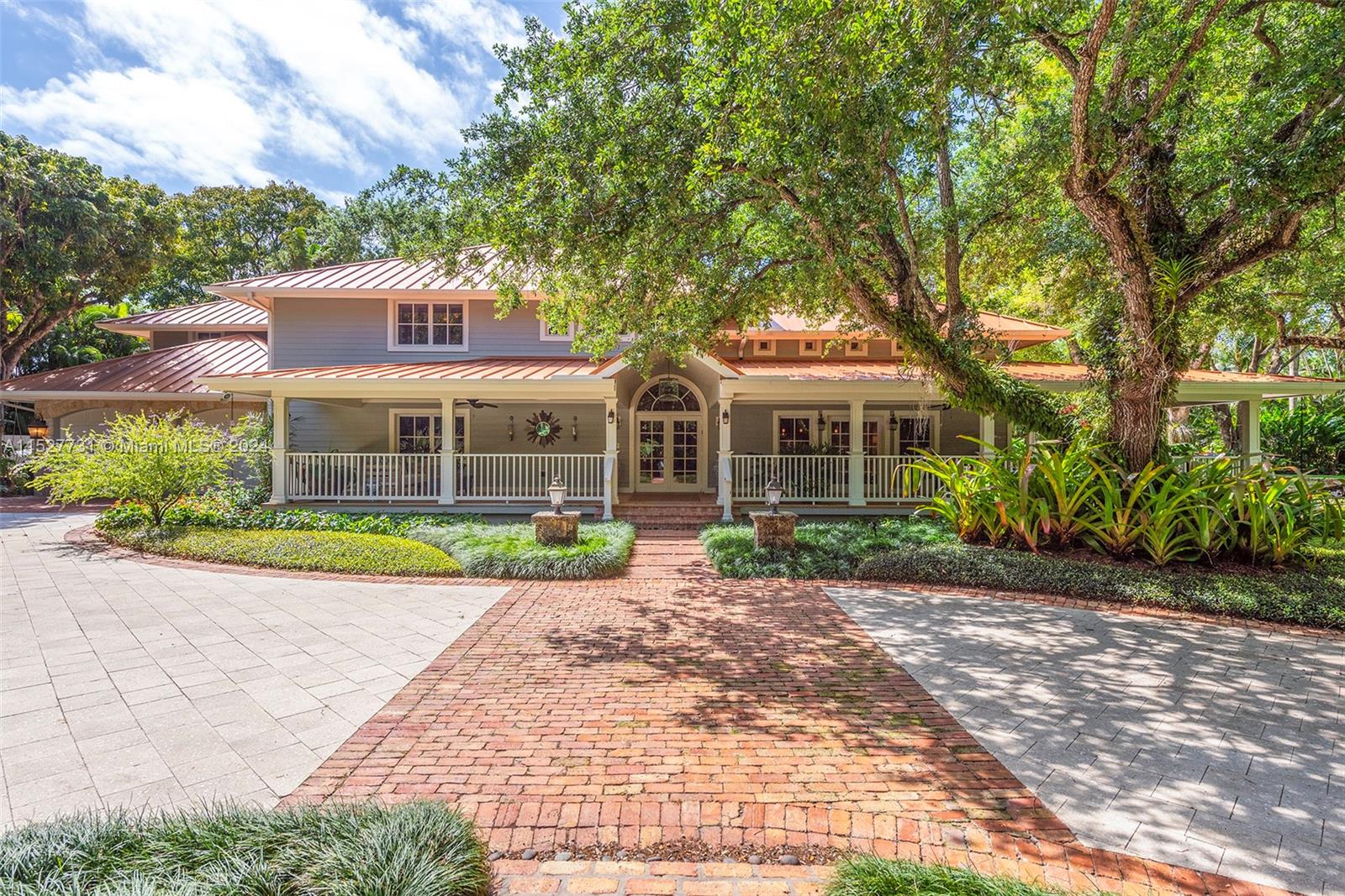 Located in the guard-gated Banyan Lakes neighborhood, this 2003 custom Old Florida estate-style home w/ wraparound porches spans 8,765 SF & is the epitome of sophisticated living.  Situated on a 50,000+ sf lot that is nothing short of magical w/ live oaks, terraced lawn, & lush landscaping around the lagoon-style pool & patio. The 6 BR, 5.2 BA home w/ floorplan that calls for entertaining features a formal liv rm that opens to a zen garden & family rm w/ custom built-ins & fireplace. The bespoke kitchen incl Caesarstone counters, Wolfe & Subzero appliances, banquette & butlers pantry.  The primary ste has  large BR, gym, 2 walk-ins, & spa-like BA. There are 4 add’l BRs upstairs + office. White oak floors, impact glass, 2014 metal roof, generator, 2-car gar are some of the special features.