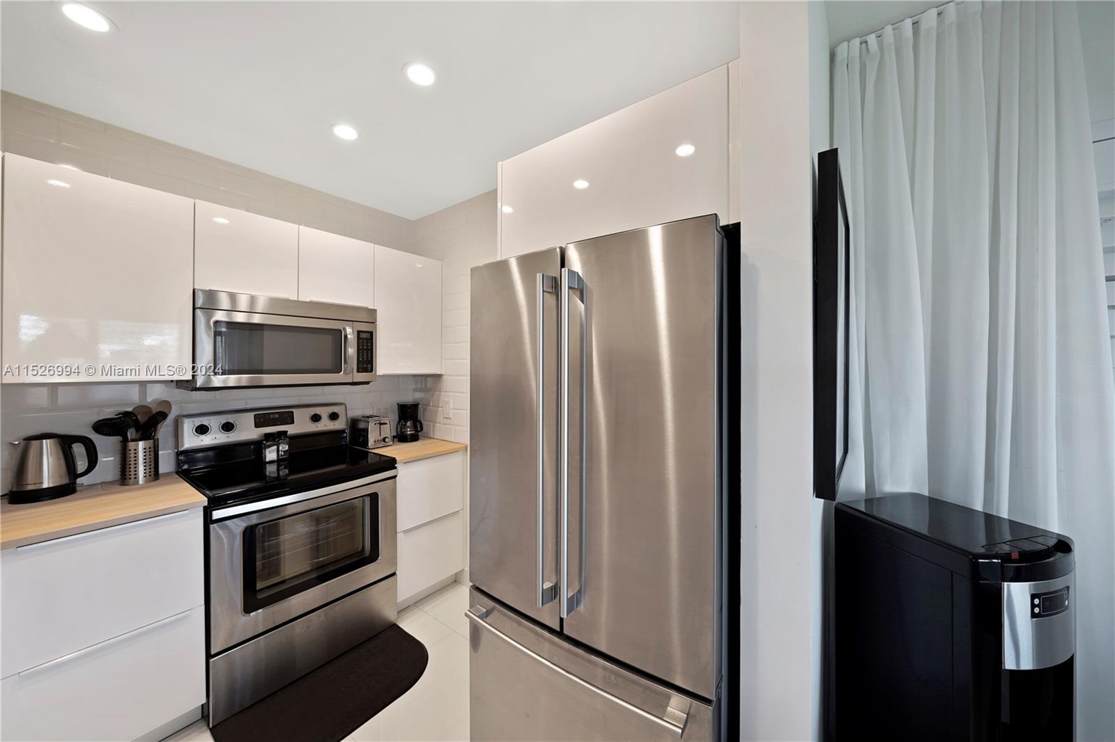 HIGH GLOSS CABINETS with NEW STAINLESS APPLIANCES