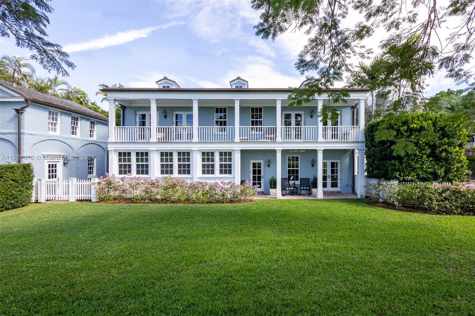 One of five original Coral Gables pioneer village homes, this impeccable 1938 8,711 SF estate on picturesque Santa Maria Street overlooks the 15th hole of the Riviera Golf Course. The 5-bedroom, 4-bathroom and 2 half-bath home has large living spaces,  wraparound balconies, and great views from every room. A renovated gourmet eat-in kitchen has an impressive center island with seating, quartz countertops, luxury appliances, gas stove, and butler’s pantry. Magnificent outdoor entertaining areas have a pool, manicured gardens, large gazebo with plenty of seating, and full summer kitchen with built-in grill and pizza oven. Includes a guesthouse, whole-house generator connected to the city gas line, new hurricane shuttering, 2-car garage, and new slate roof.
