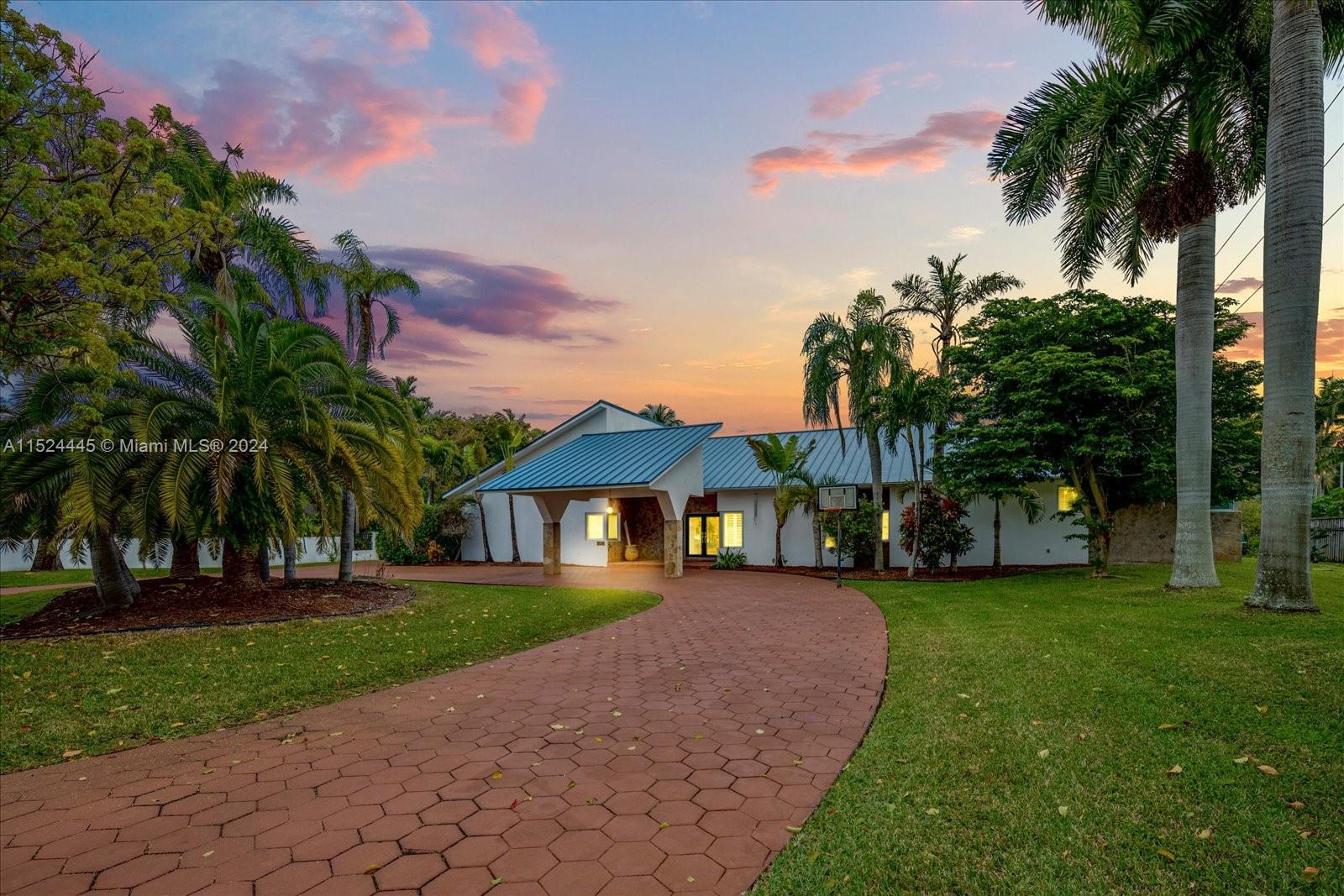 Beautiful, sprawling estate residence located on a cul-de-sac * 2019 metal roof with a modern style porte cochere * Full impact windows & doors * Spacious living, dining and family rooms all with stunning tongue & groove vaulted ceilings * Plantation shutters * Fully equipped wet bar in the family room and another bar in the extended 56' X 11' patio * 38' X 18' delightful tiki hut with BBQ * Main bedroom suite offering a private sitting area & balcony on the 2nd floor * Additional 3 en-suite bedrooms on ground floor plus an office, half bath and 1/1 attached guest house perfect for in-laws or home office with a private entrance * Recently updated bathrooms * 3 newer A/Cs * Generator ready * Separate laundry room * Perfect house for indoor & outdoor entertainment * Priced below appraisal *