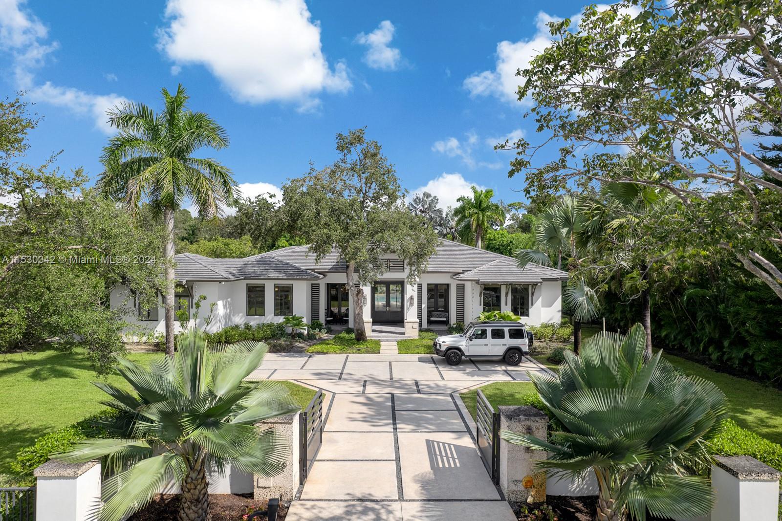 Luxury awaits in this Pinecrest modern estate, custom-built in 2020 with state-of-the-art construction and impeccable finishes. Set on a spacious 32,234 sq. ft. corner lot, this single-story residence boasts a 5-bed/5.5 bath open floor plan and a 2-car garage with impact windows & doors throughout. Enjoy expansive living areas, a family room, a wine gallery, and a bar – perfect for entertaining. The kitchen is a chef's dream with top-of-the-line Thermador appliances, a walk-in pantry, custom wood cabinetry, & quartz countertops. The master suite features double walk-in closets and a resort-style bathroom. Outside, indulge in the beautiful pool and a perfect backyard oasis for entertaining. Luxuriate in a lifestyle seamlessly blending sophistication with home comforts. By appointment only.